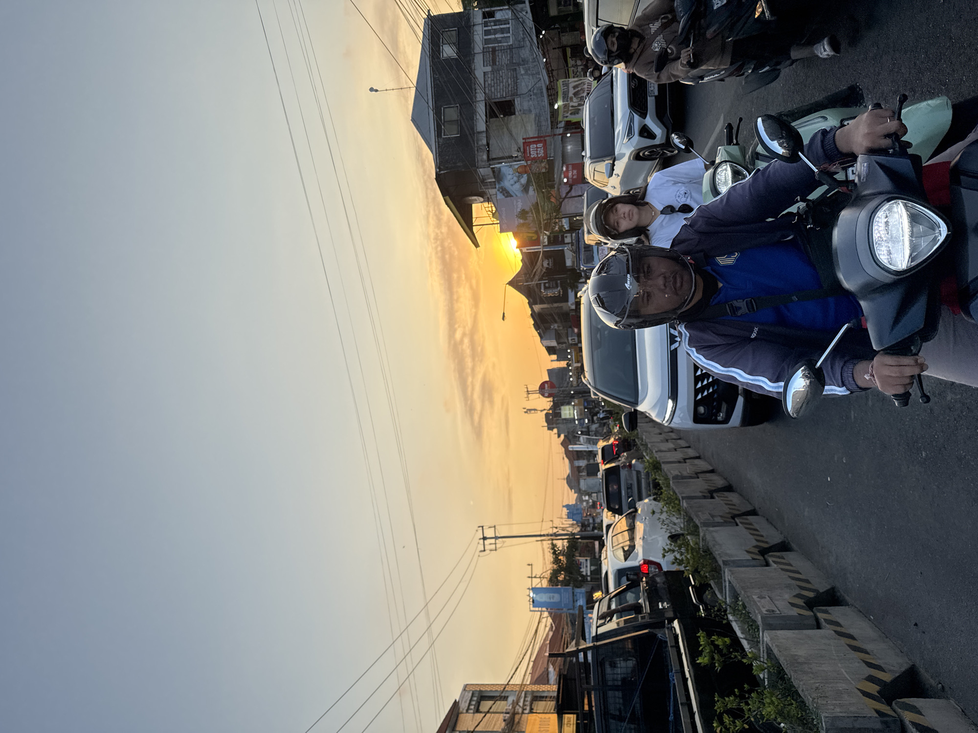 Rush hour traffic builds on a Denpasar street at sunset