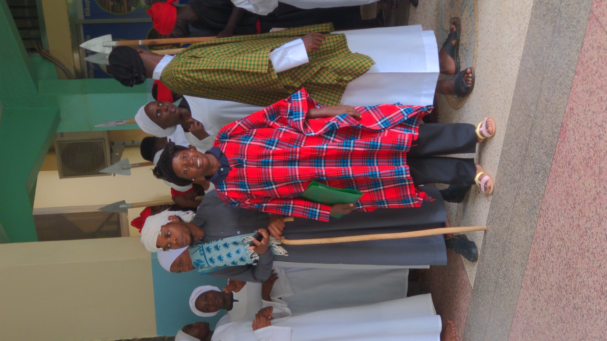 People queue indoors in Moshi, Tanzania hall