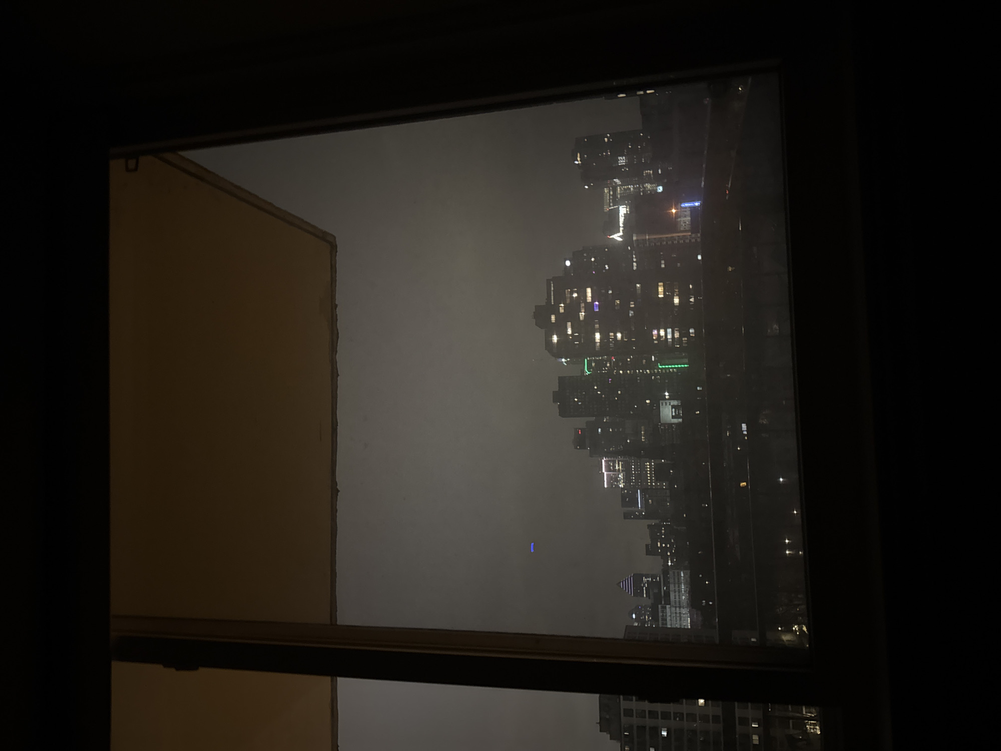 Montreal skyline viewed through window on foggy night