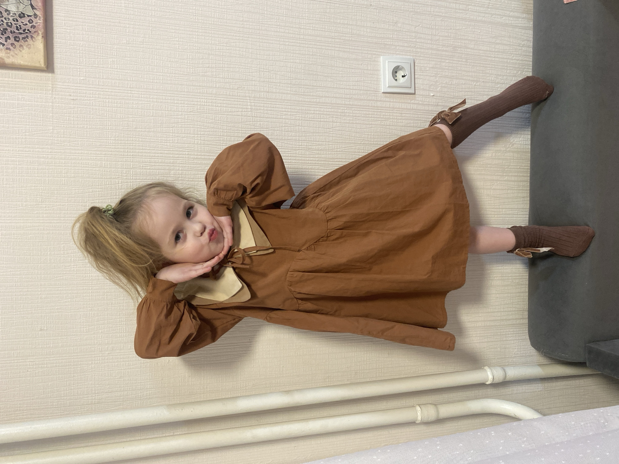 Child photographed in various outfits at Izhevsk home