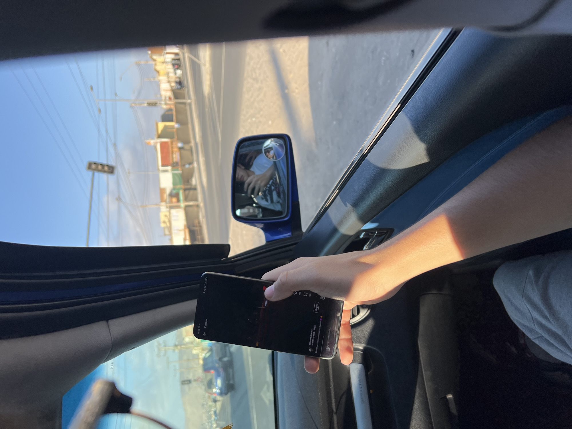 Person uses smartphone in moving car in Arica