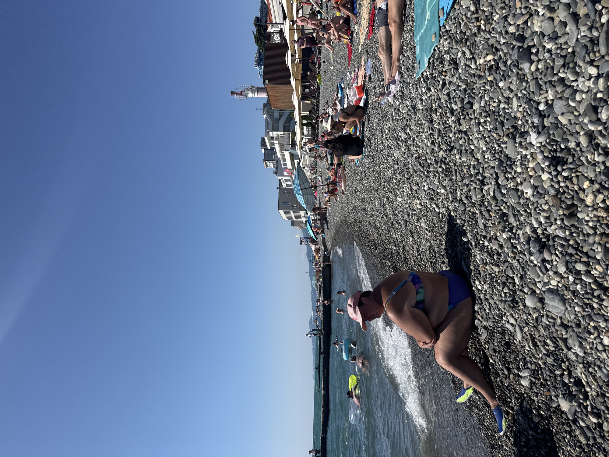 Crowded summer day on Sochi's Black Sea pebble beach