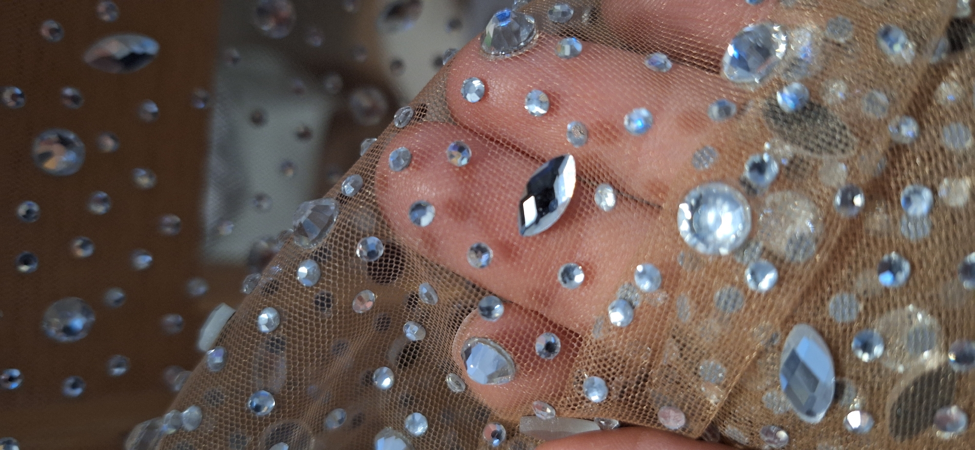 Person examines rhinestone fabric in Blagoevgrad, Bulgaria