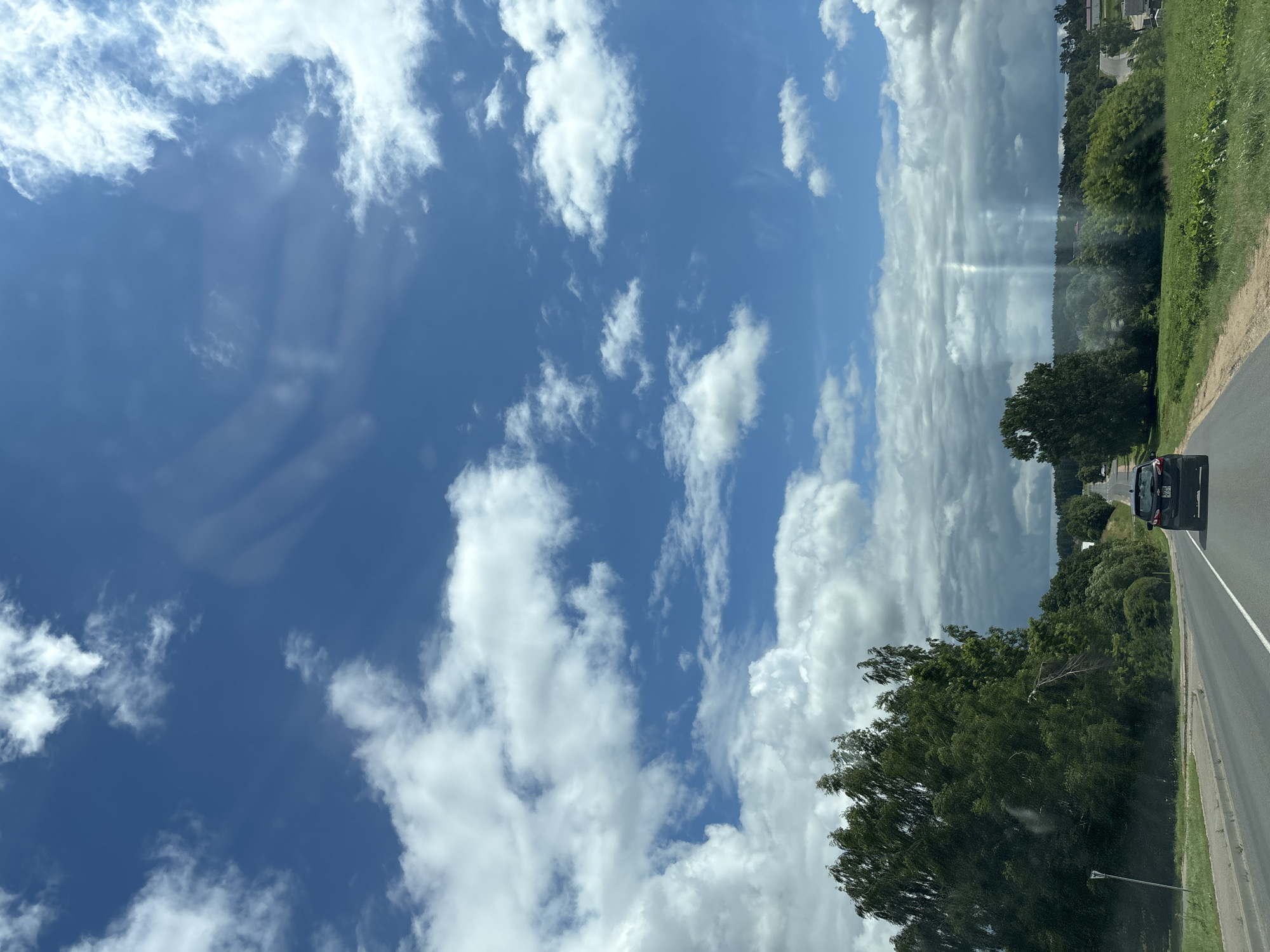 Rural drive through Kapylsky Selsoviet under a dramatic summer sky
