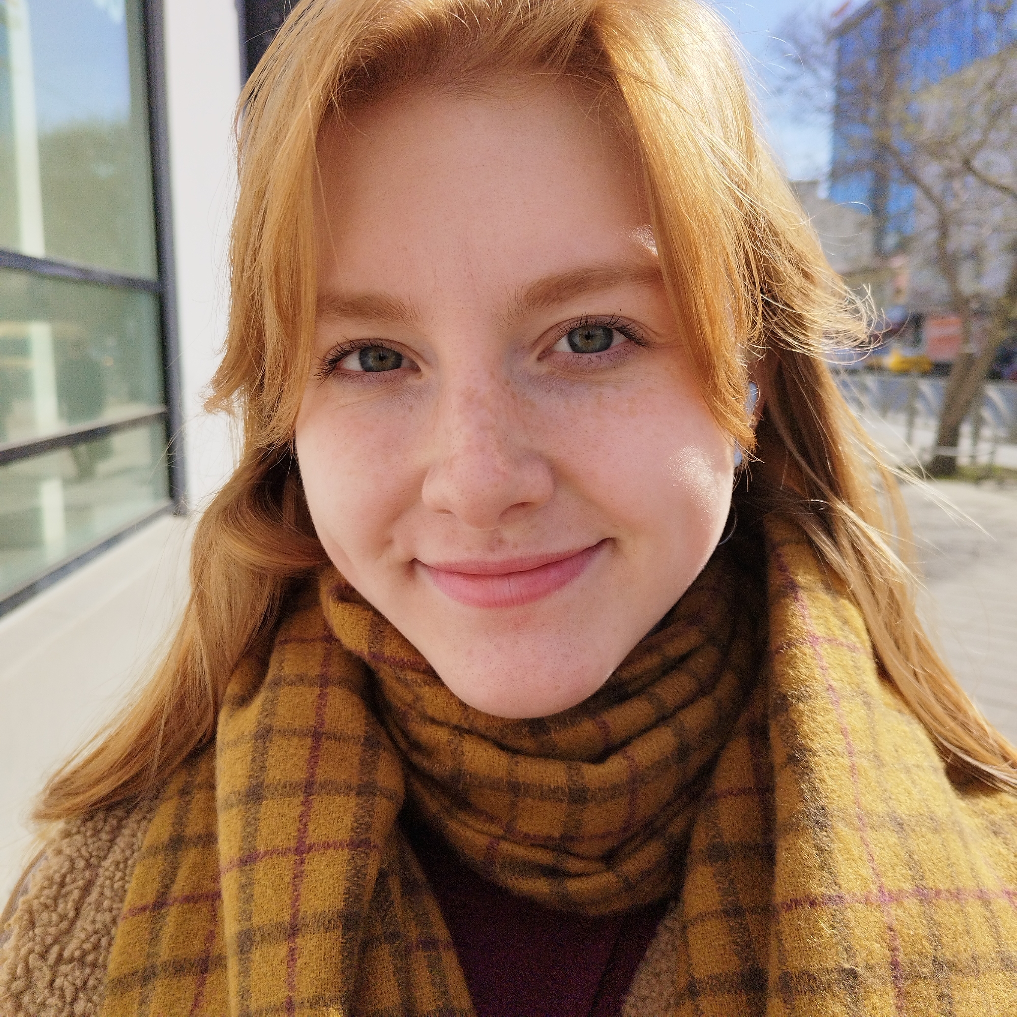Portrait of young woman with freckles captured by witness