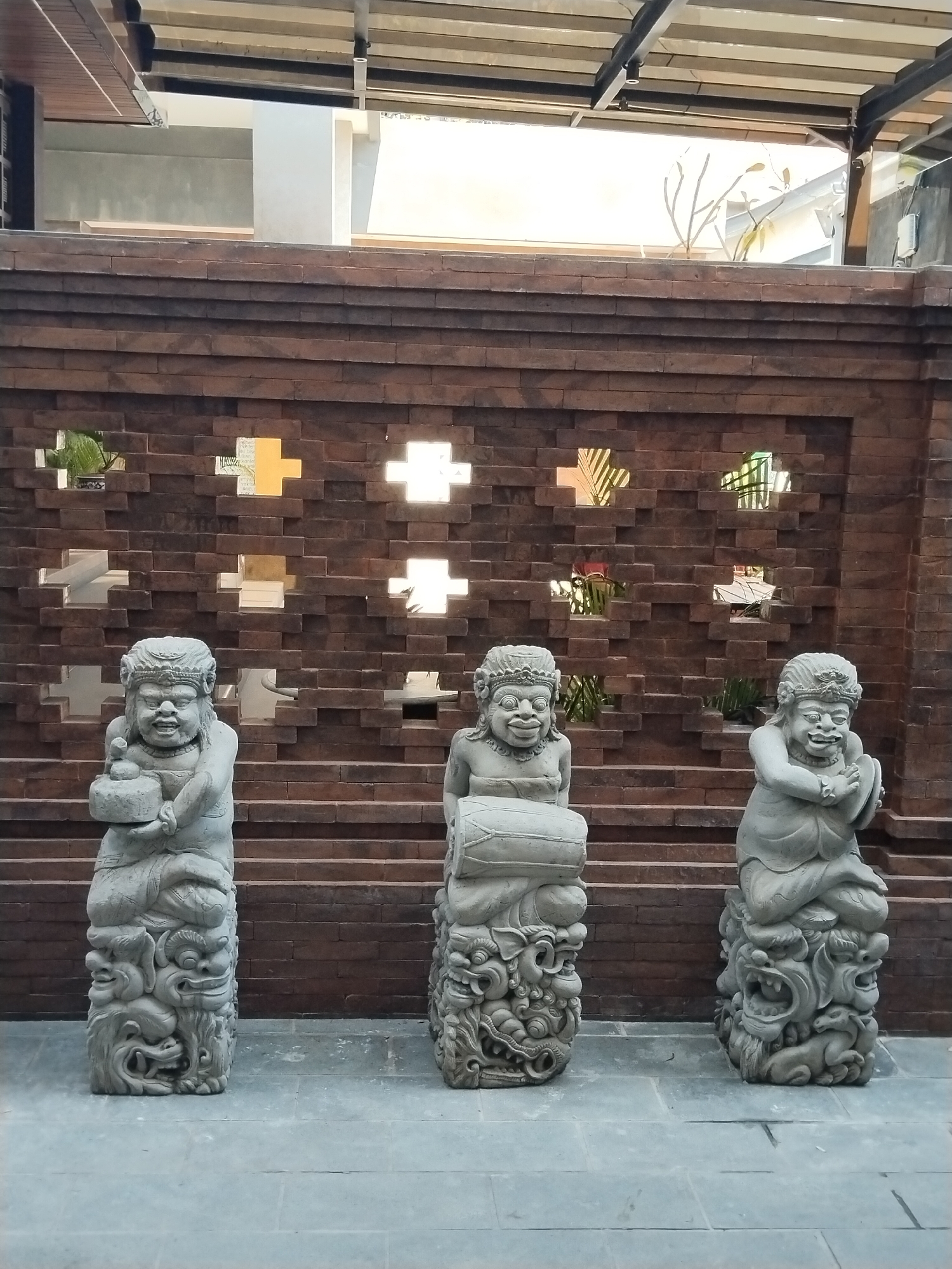 Balinese stone sculptures and koi ponds at a Kuta venue