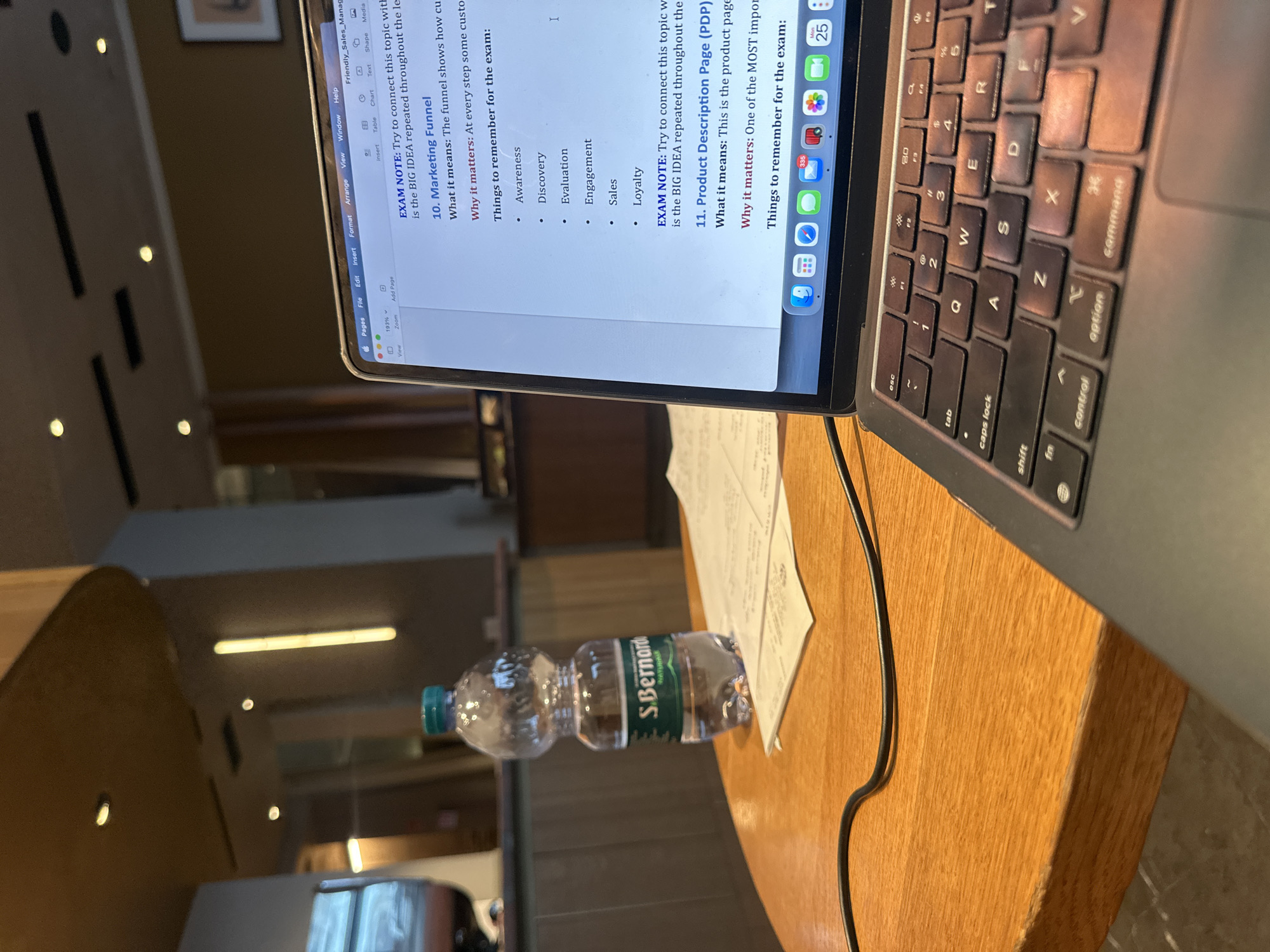 Student studies marketing concepts with laptops in Milan workspace