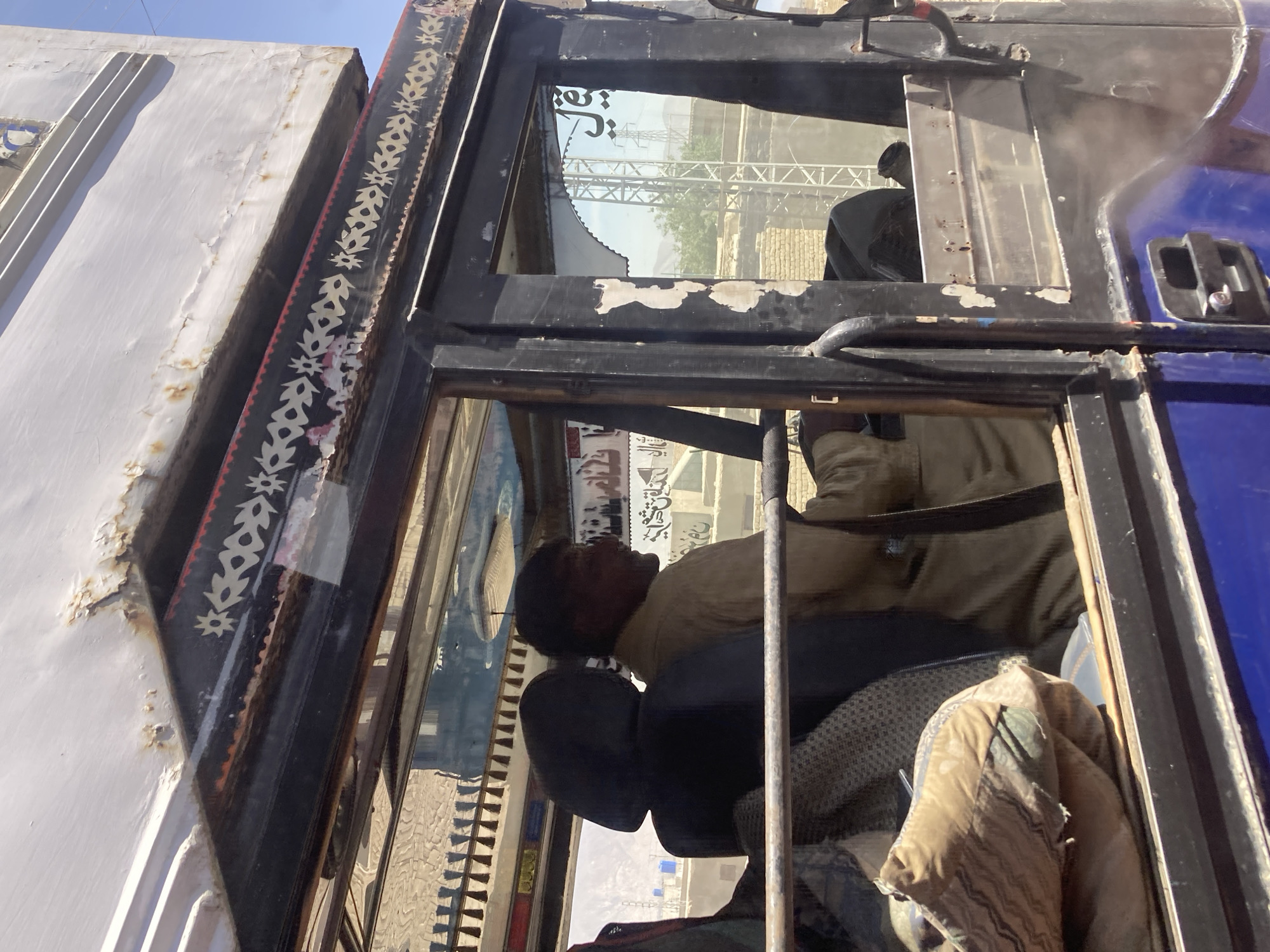 Driver rests in decorated truck cabin in Quetta