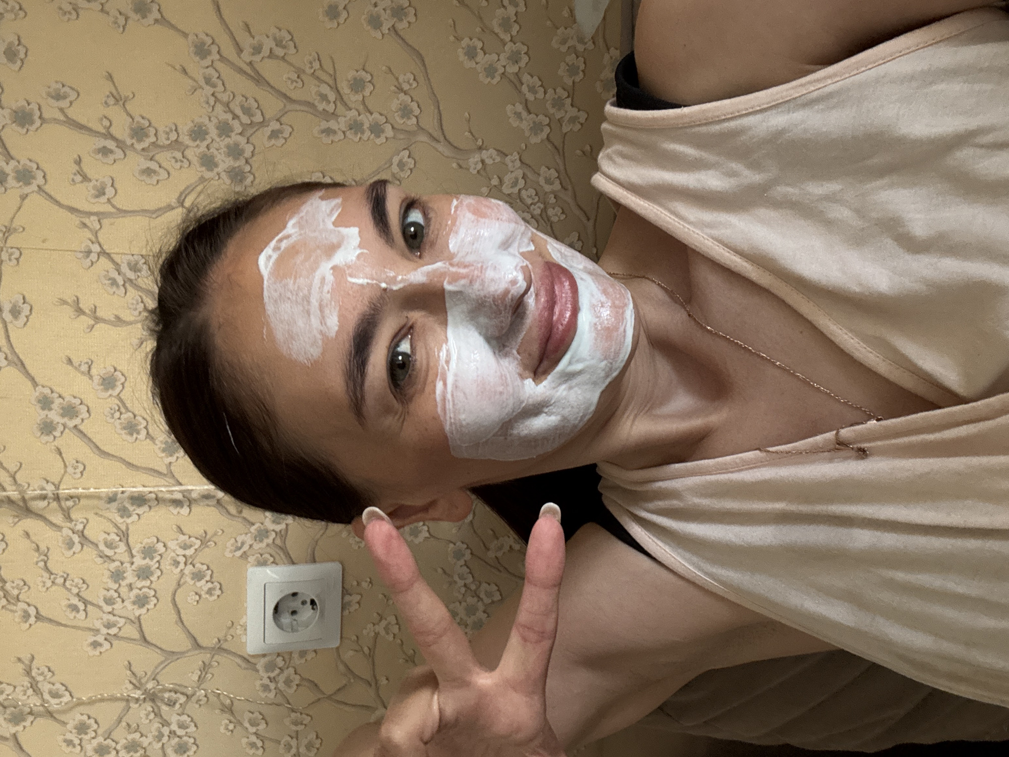 Woman enjoys morning self-care routine with face mask in Sochi