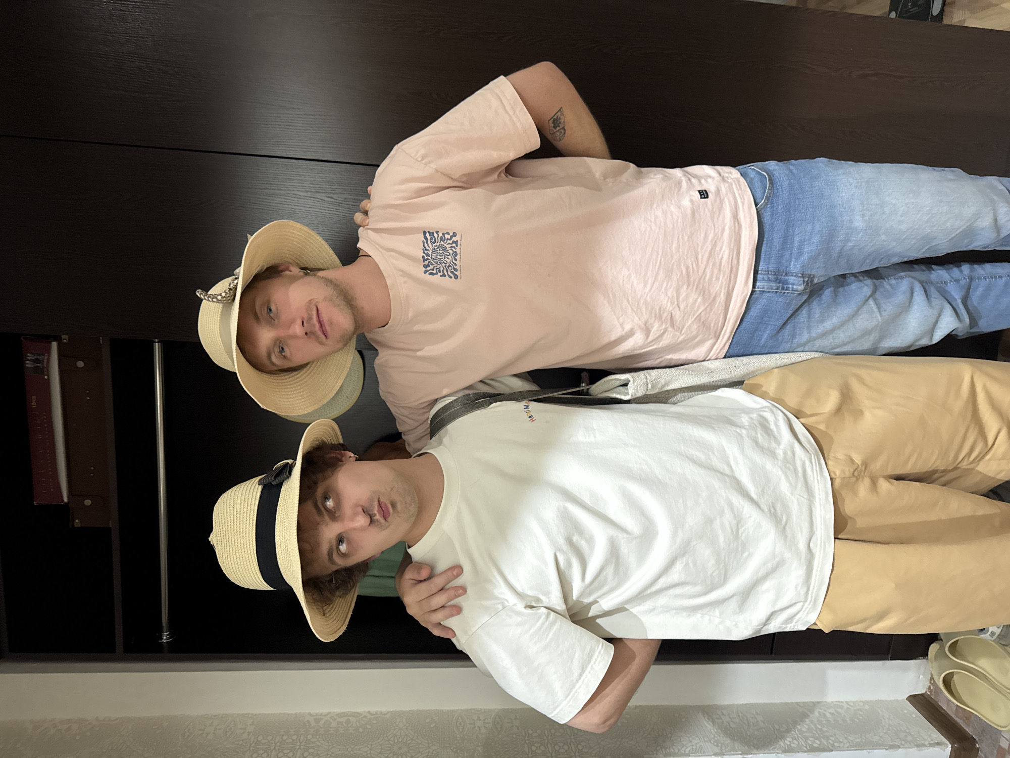 Young men in straw hats pose for photos in Tashkent