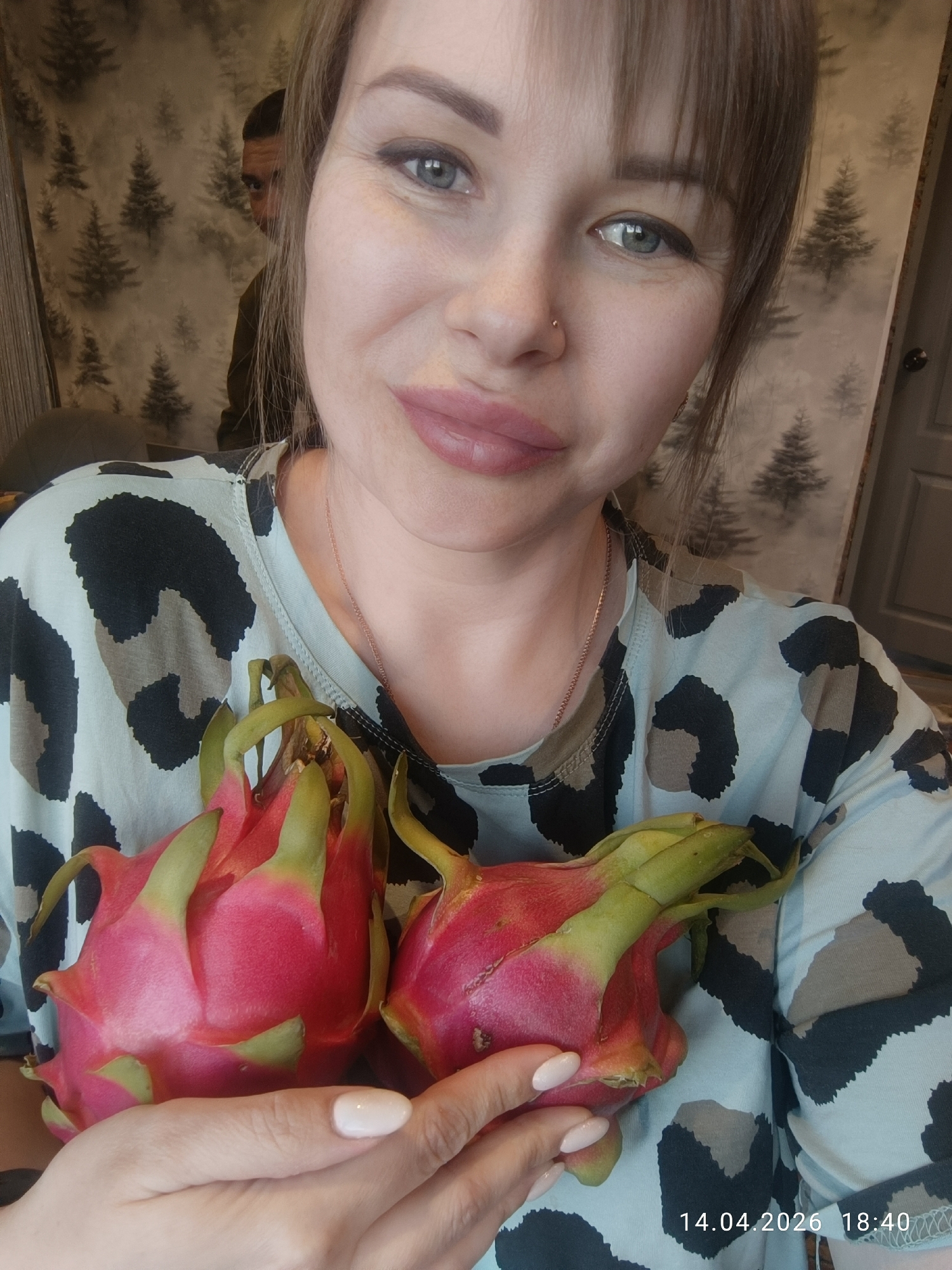 Woman holds dragon fruits in Chaikovsky, Russia