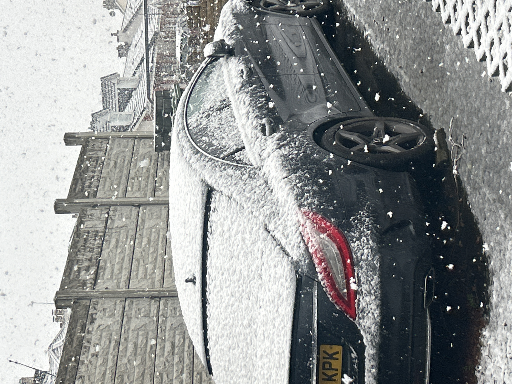Snow-covered Mercedes parked during heavy Glasgow snowfall