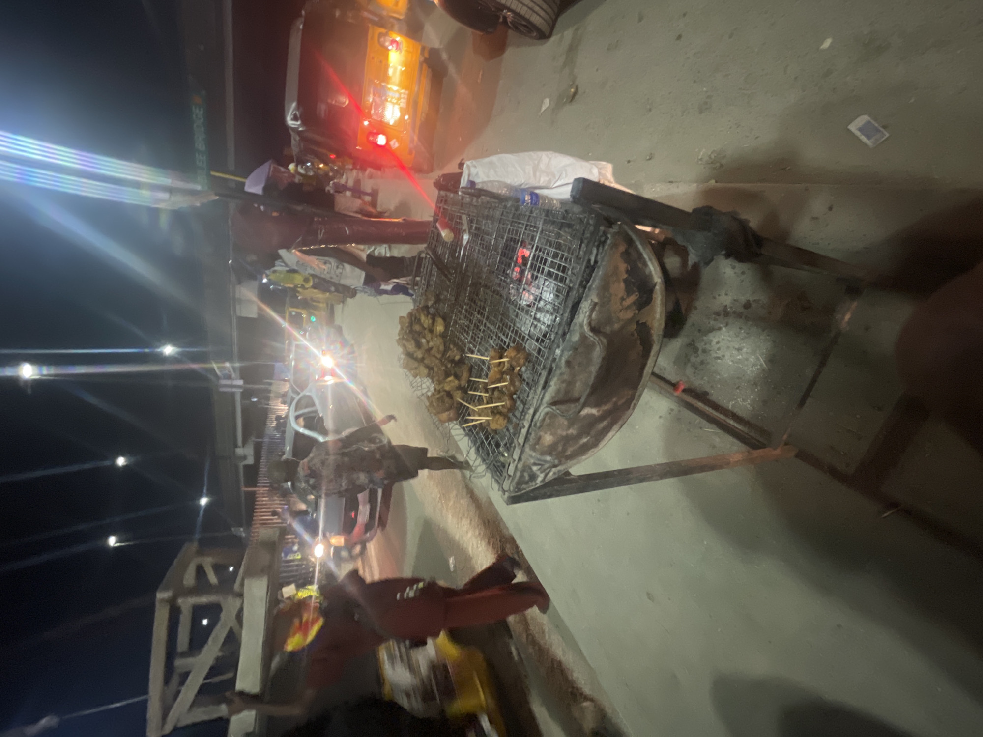 Night suya vendors serve grilled meat at Lagos street stall
