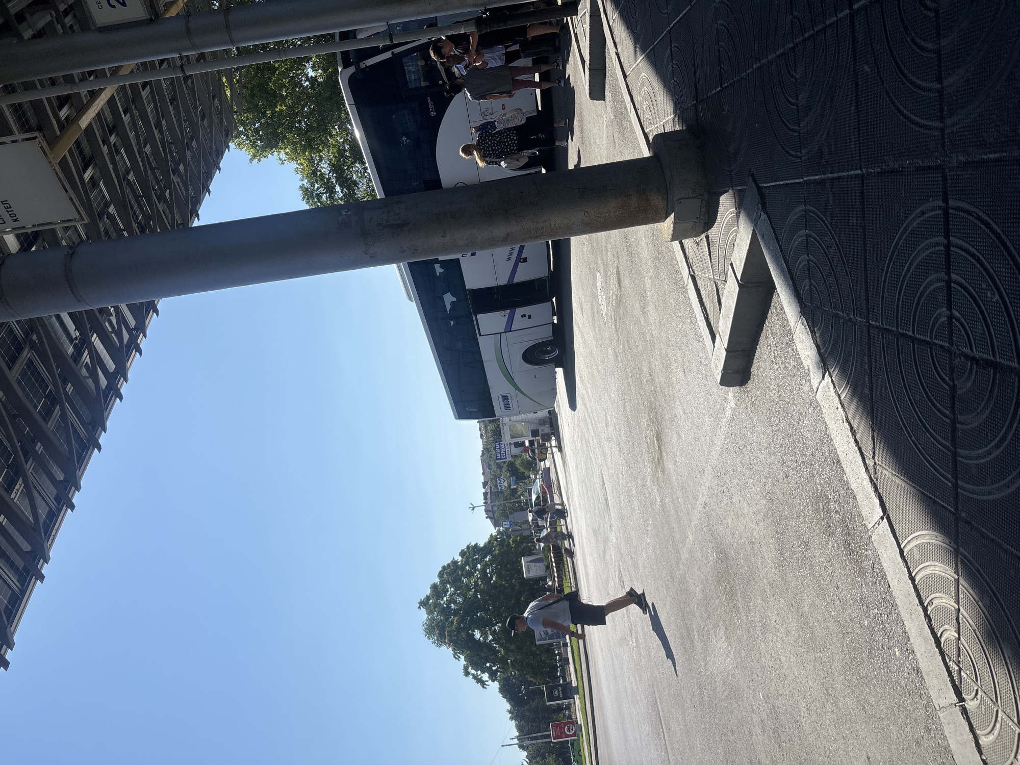 Selfie session at an outdoor transit area on a clear day