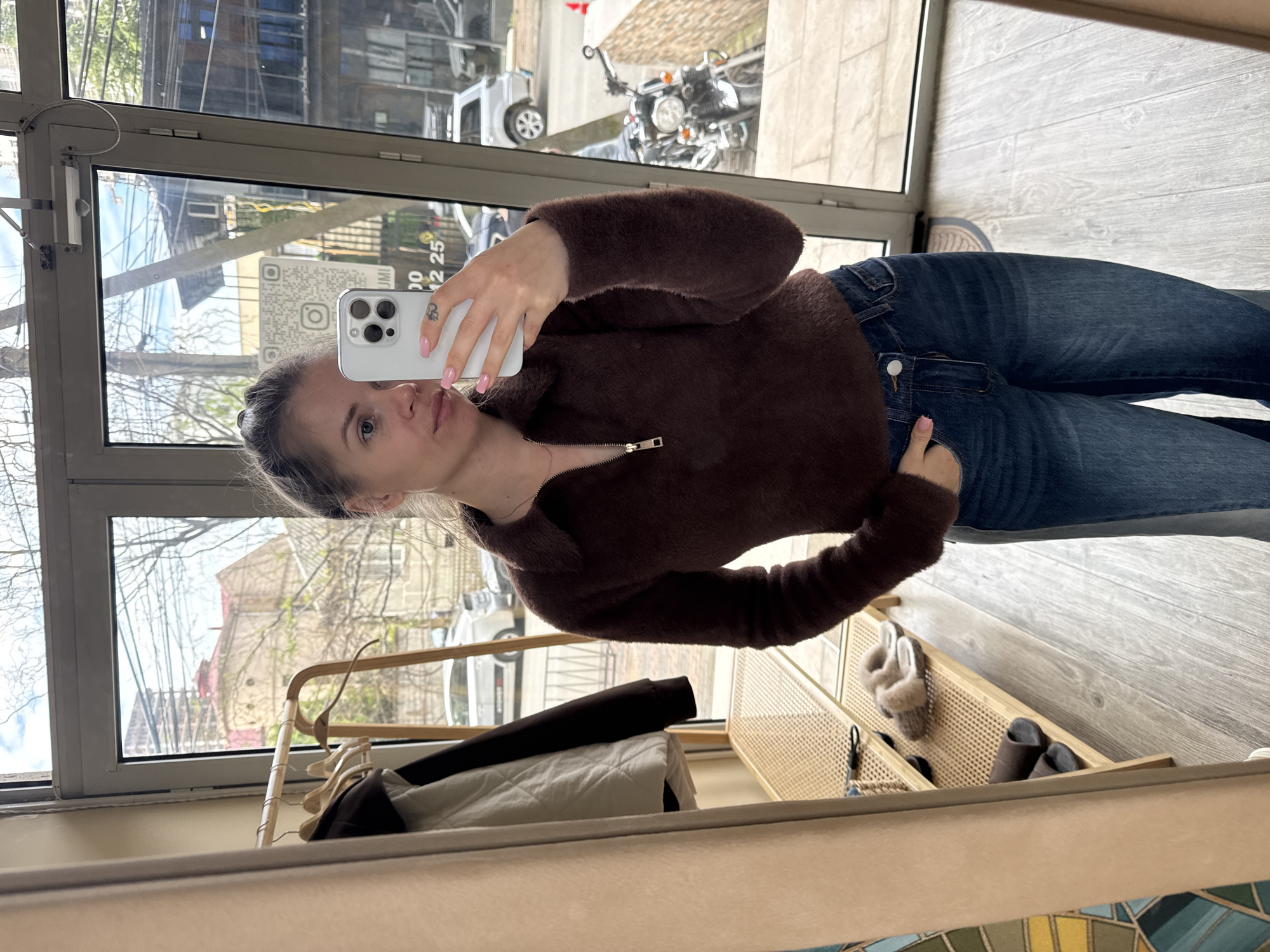 Woman takes mirror selfie in Batumi indoor space