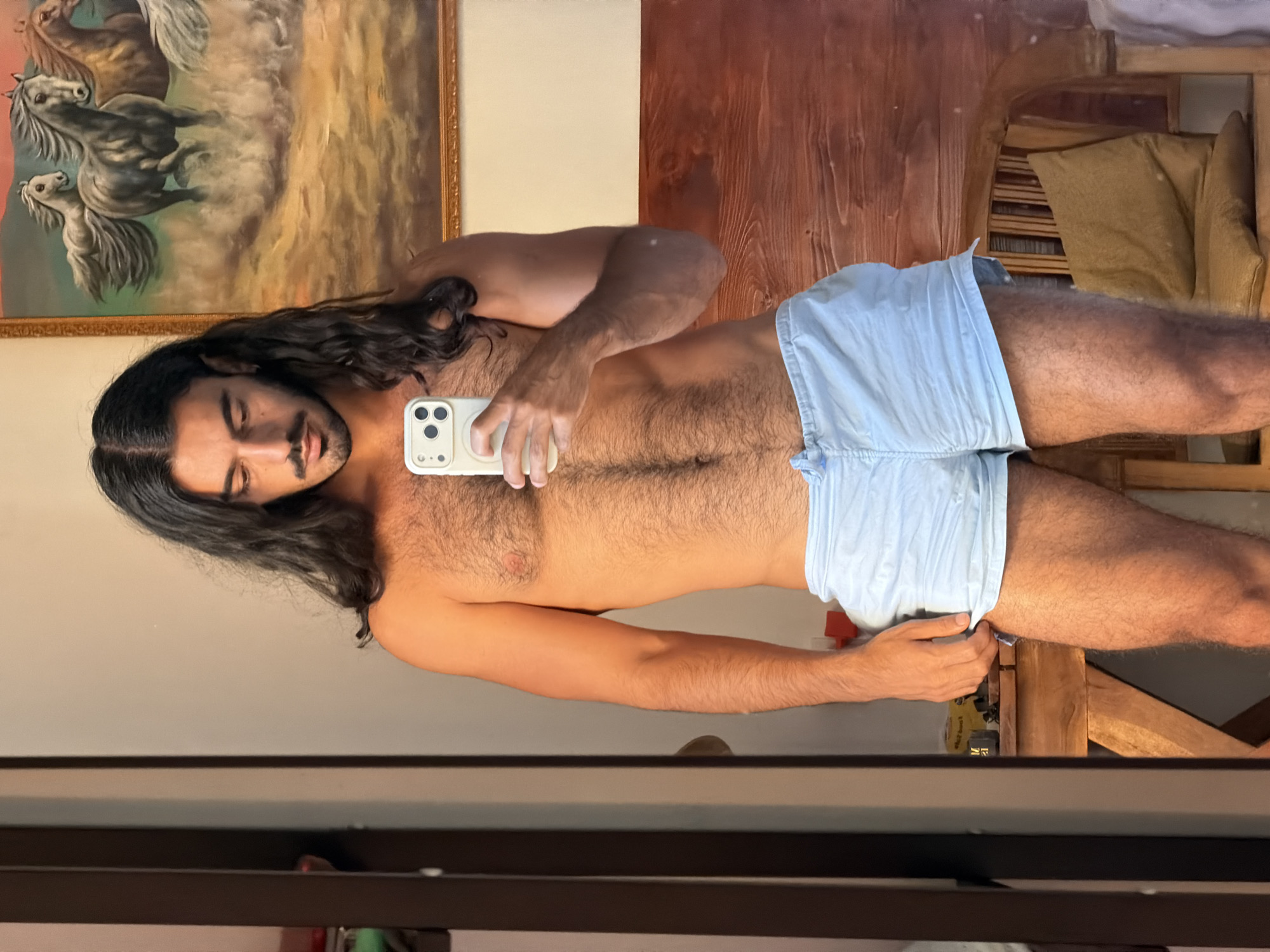 Man takes mirror selfie in North Kuta room