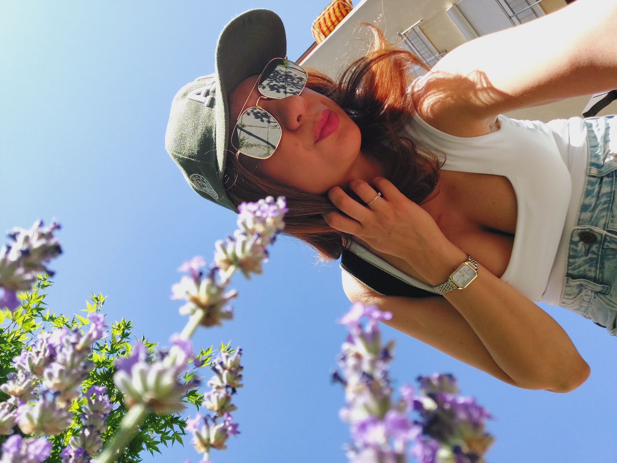 Casual balcony portrait session in Sofia, cap and shades throughout
