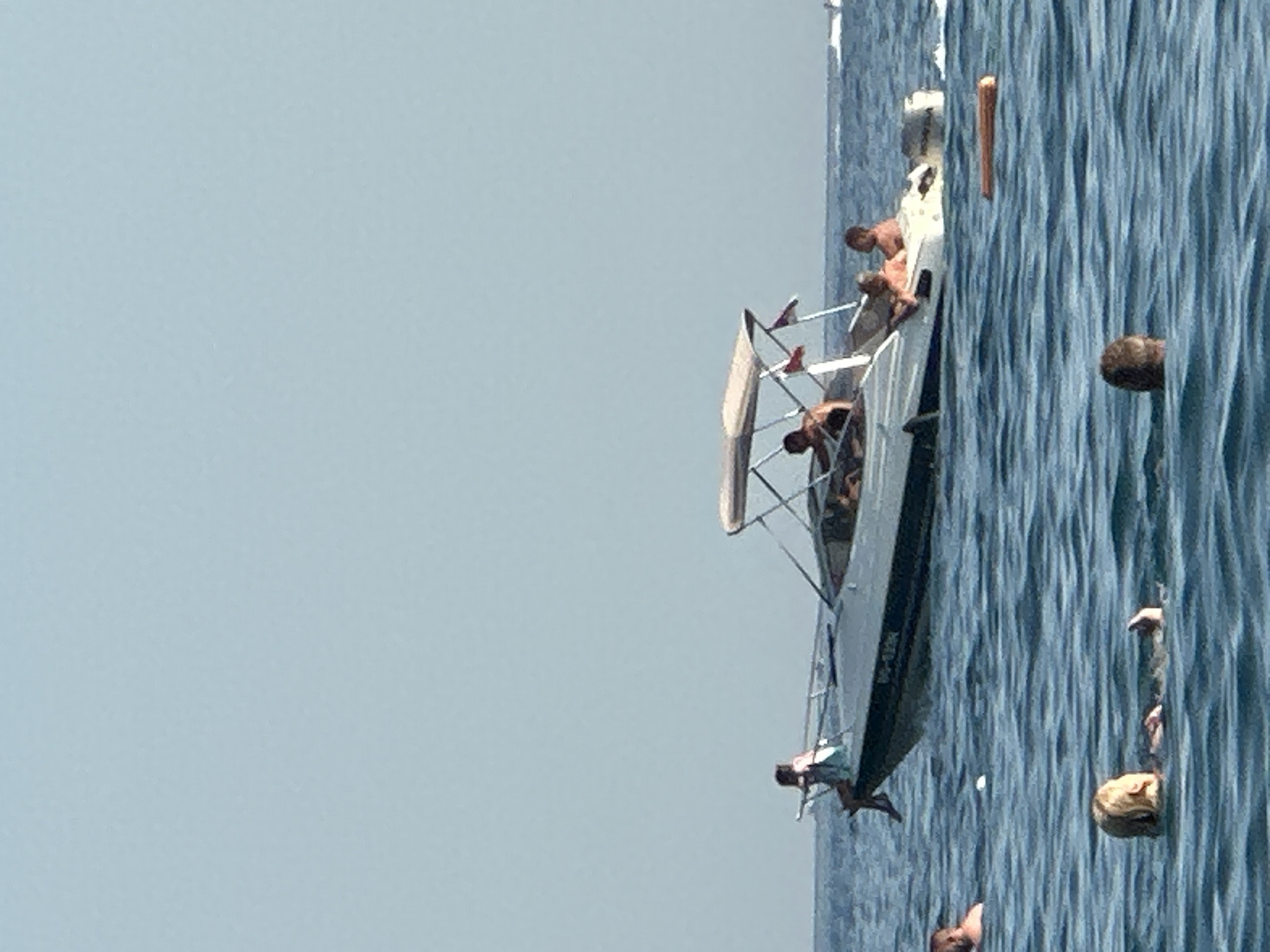 Paragliders, parasailers, and beachgoers fill a Montenegrin summer afternoon