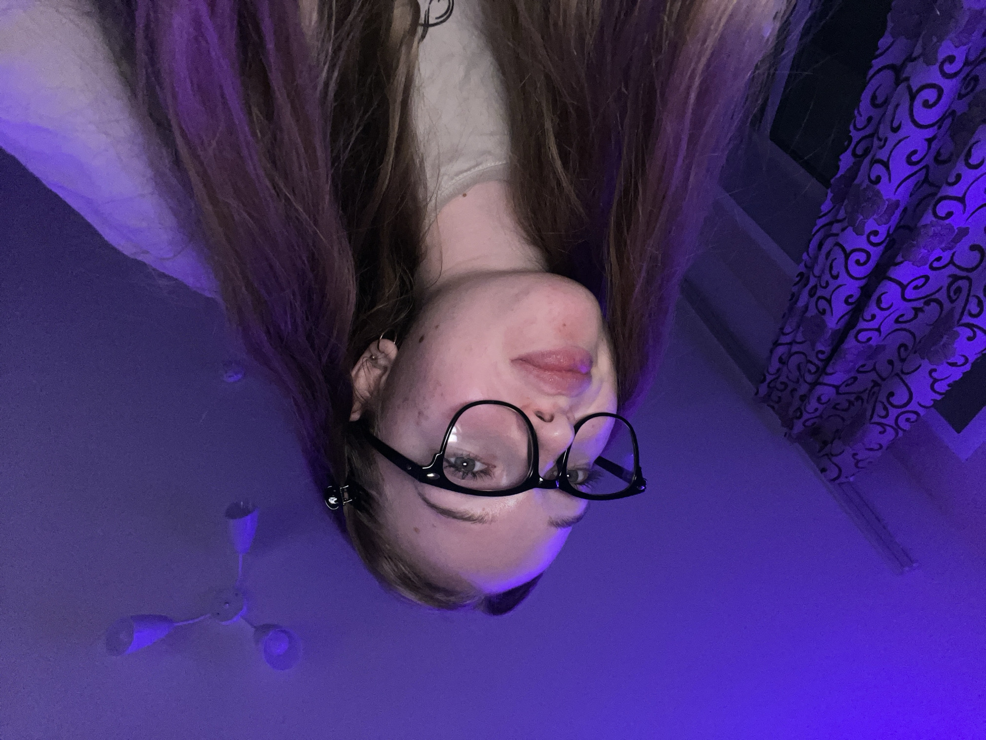 Woman takes selfies with cat in LED-lit room