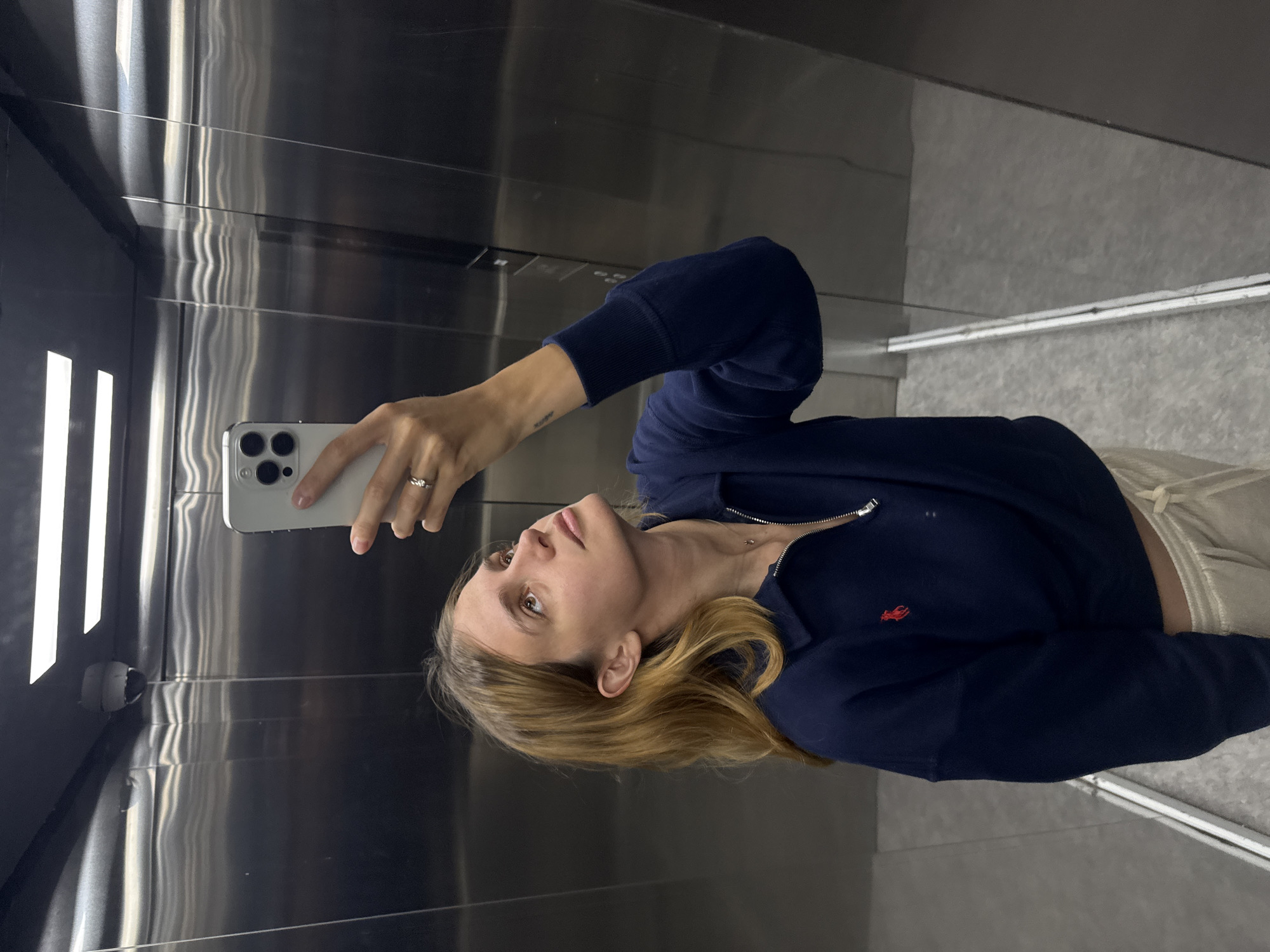 Woman takes elevator selfie in silver-clad lift
