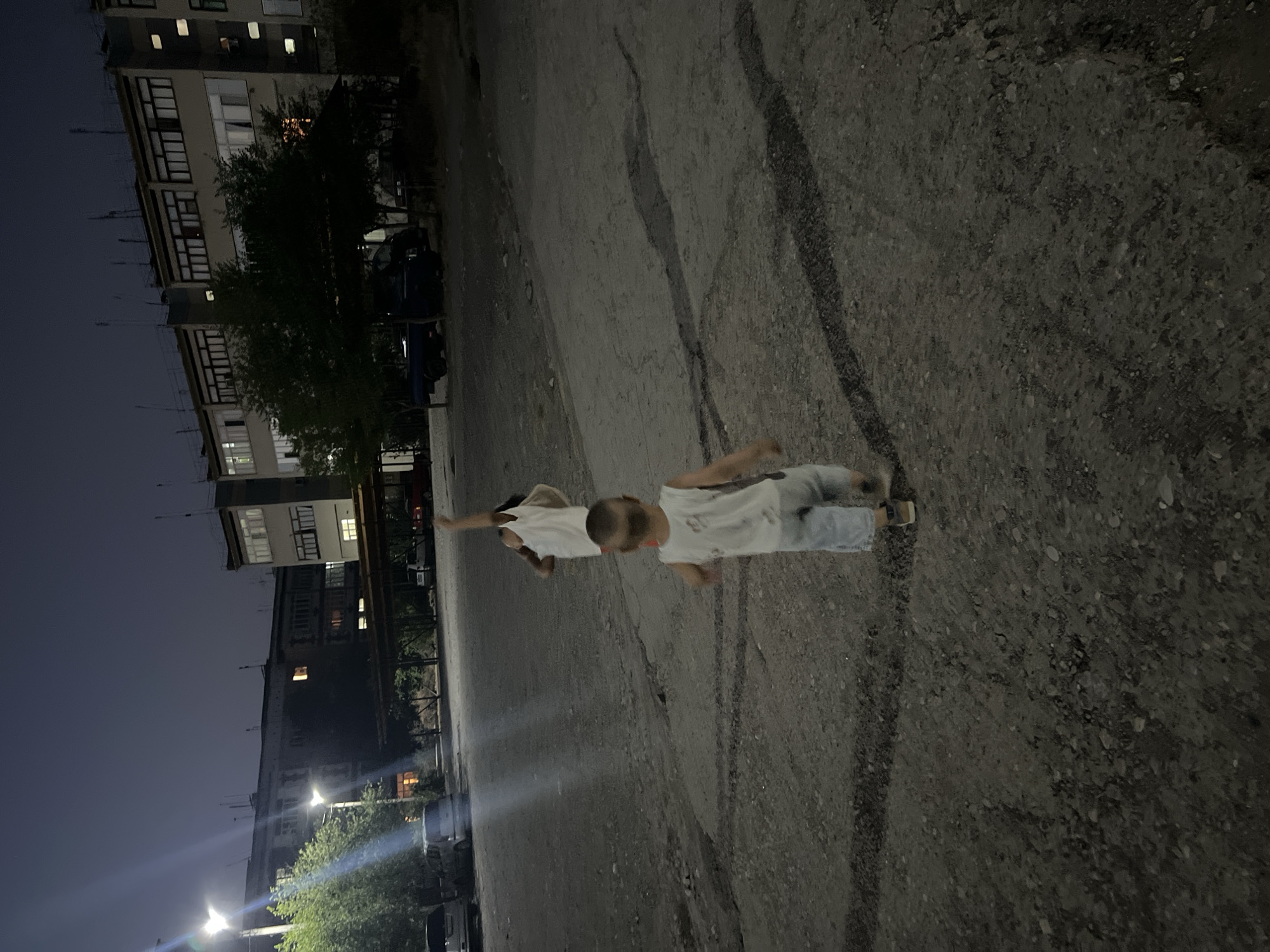 Evening street life outside a Şamaldı-Say apartment block