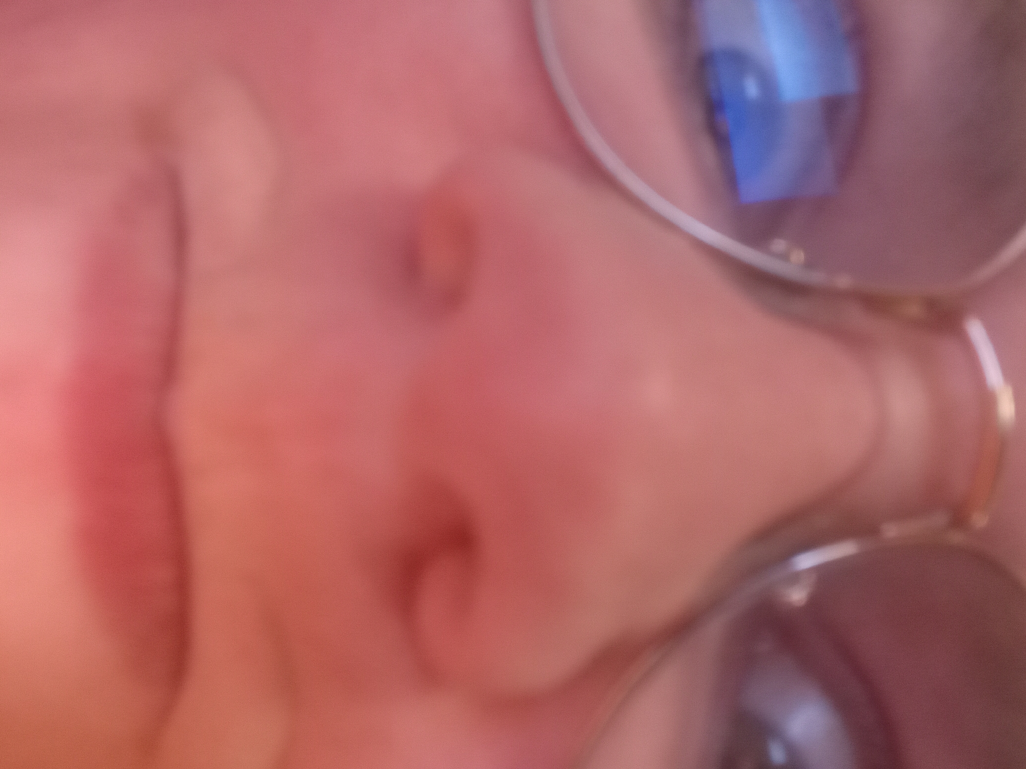 Person with glasses encounters gaming controller connection issues indoors