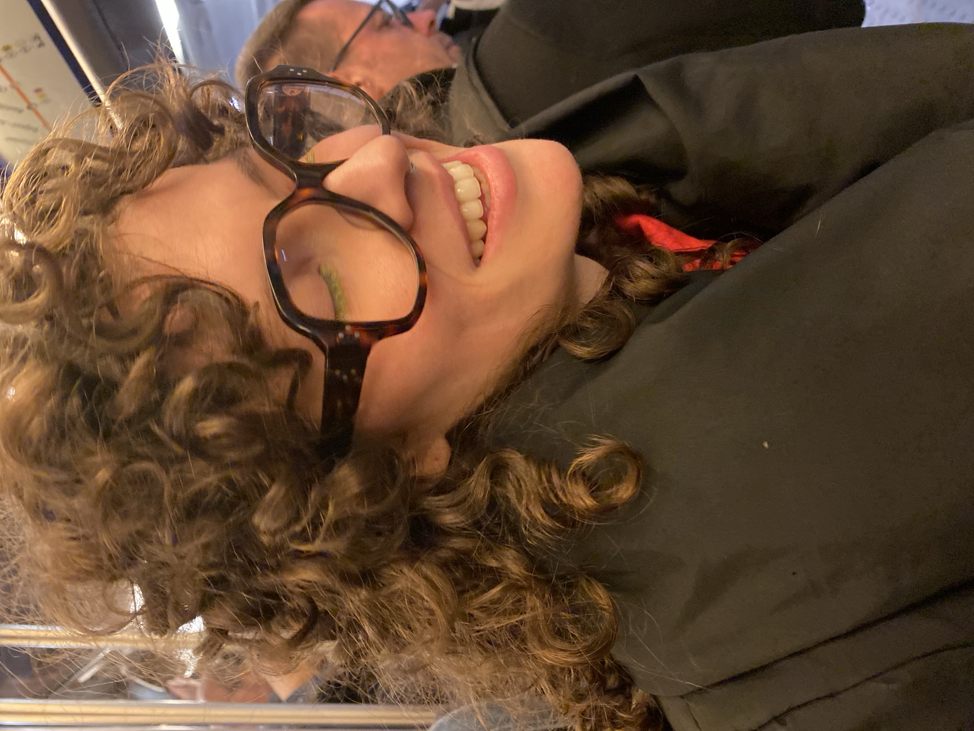 Woman photographed smiling in Paris street scene
