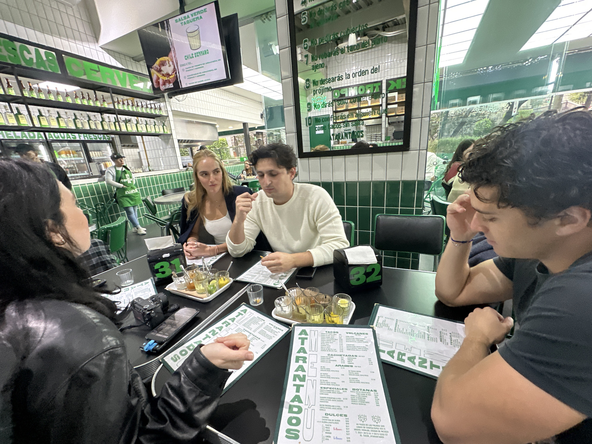Four diners gather at Mexico City taco restaurant