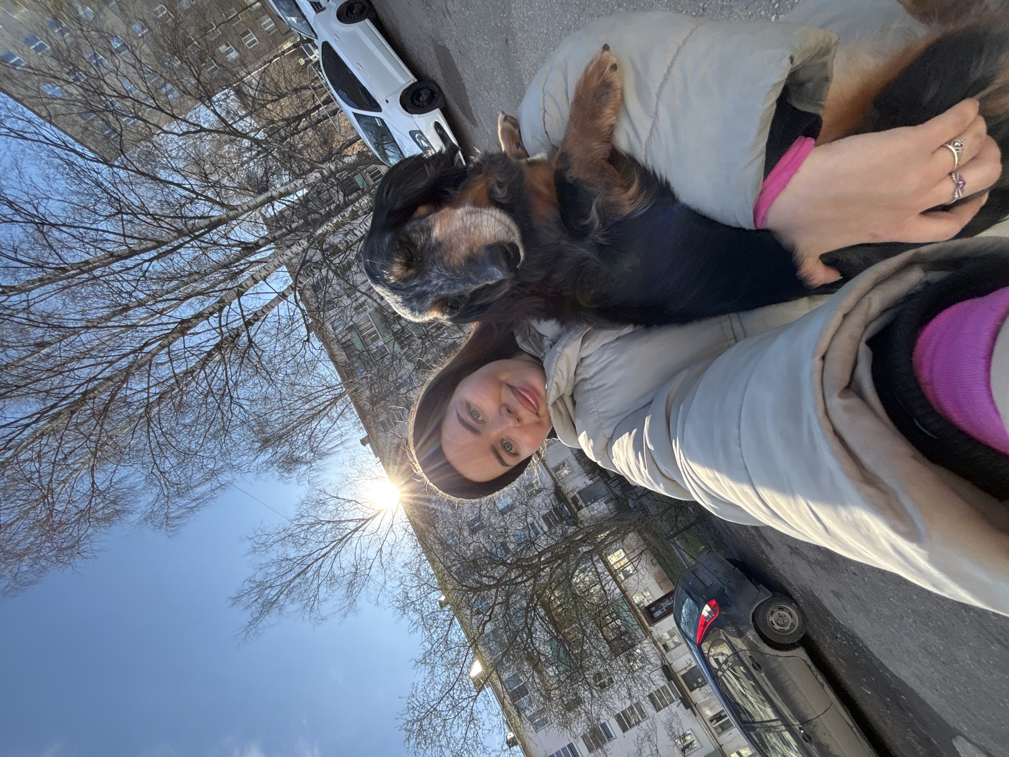 Woman takes sunny day selfie with dog in Izhevsk