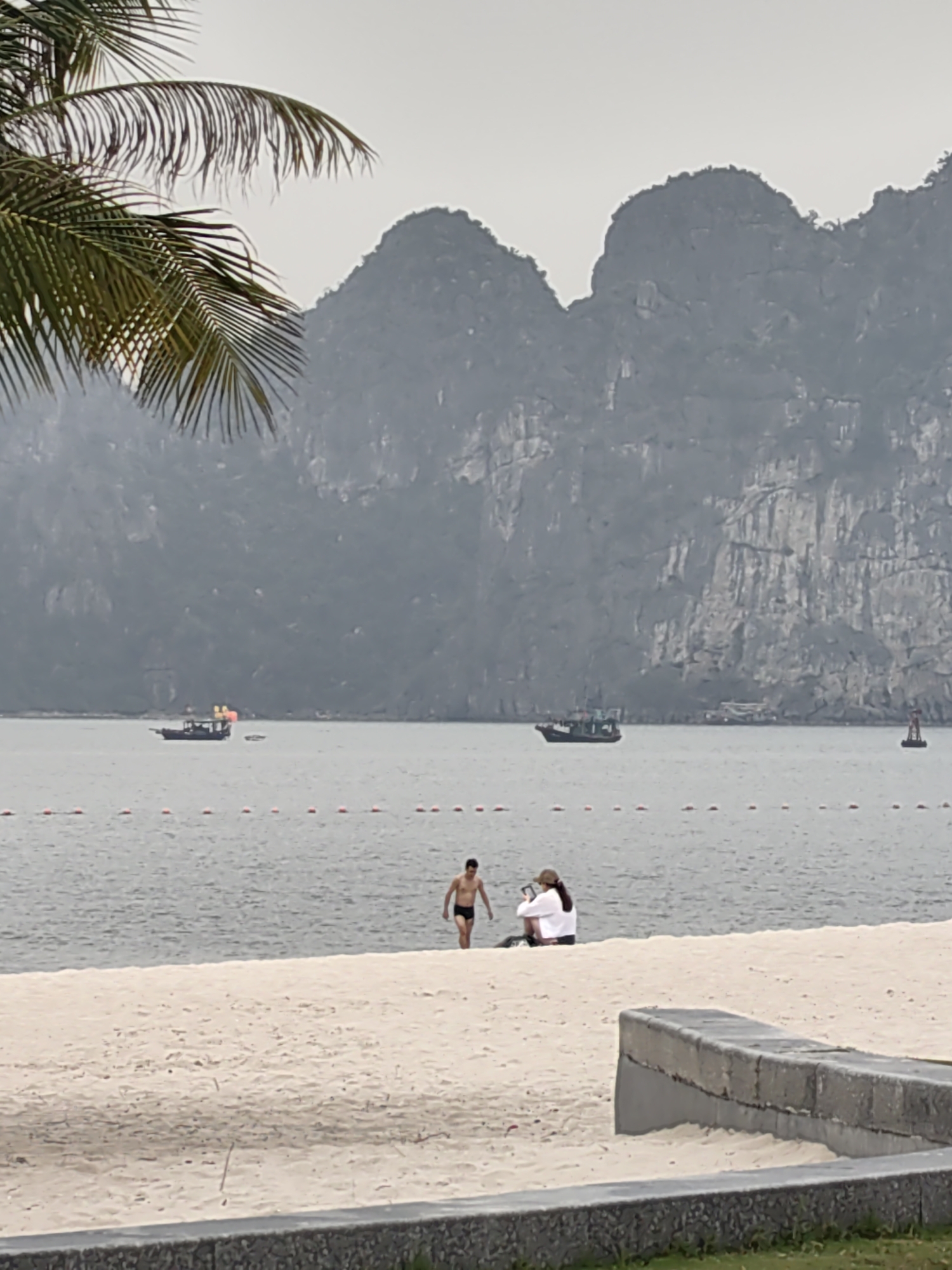 Tourist enjoys early morning mango at Ha Long Bay
