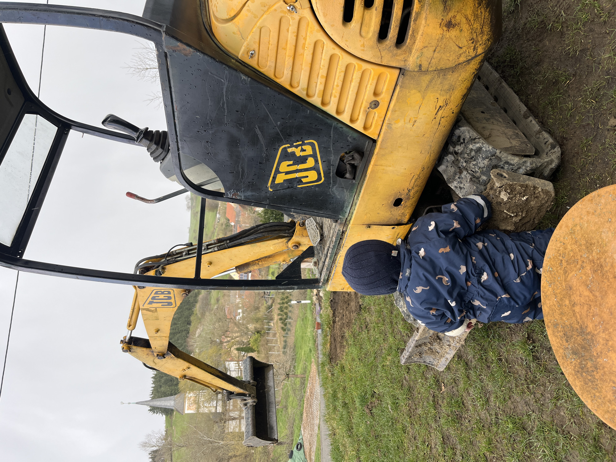 Family yard work day with toddler, corgi, construction equipment