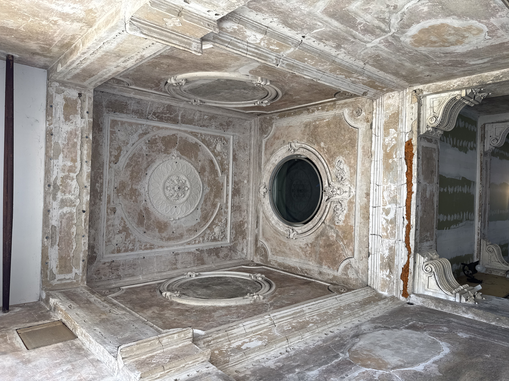 Ornate deteriorating room with decorated ceiling documented in Milan
