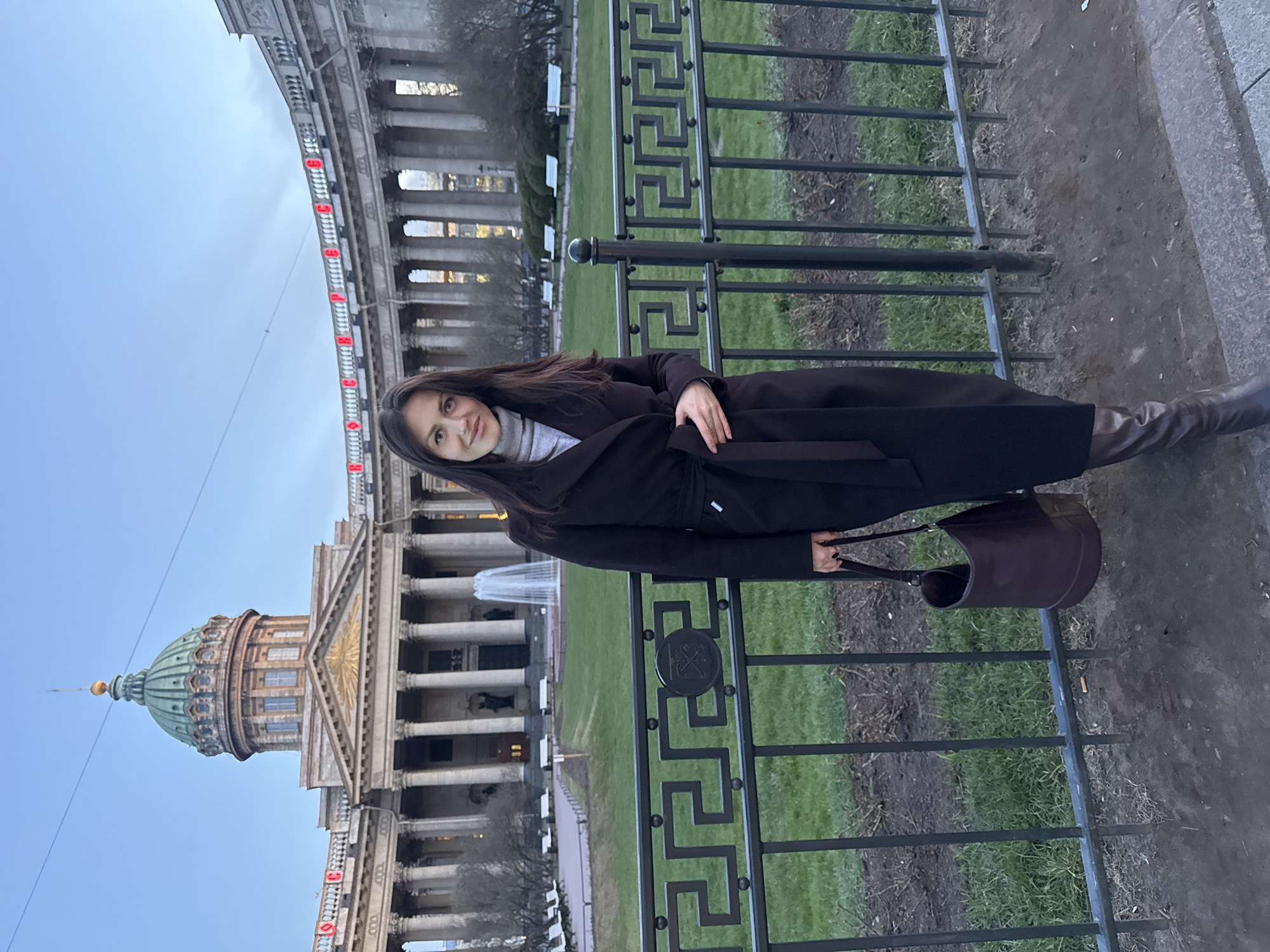 Woman poses for photo at Kazan Cathedral in Saint Petersburg
