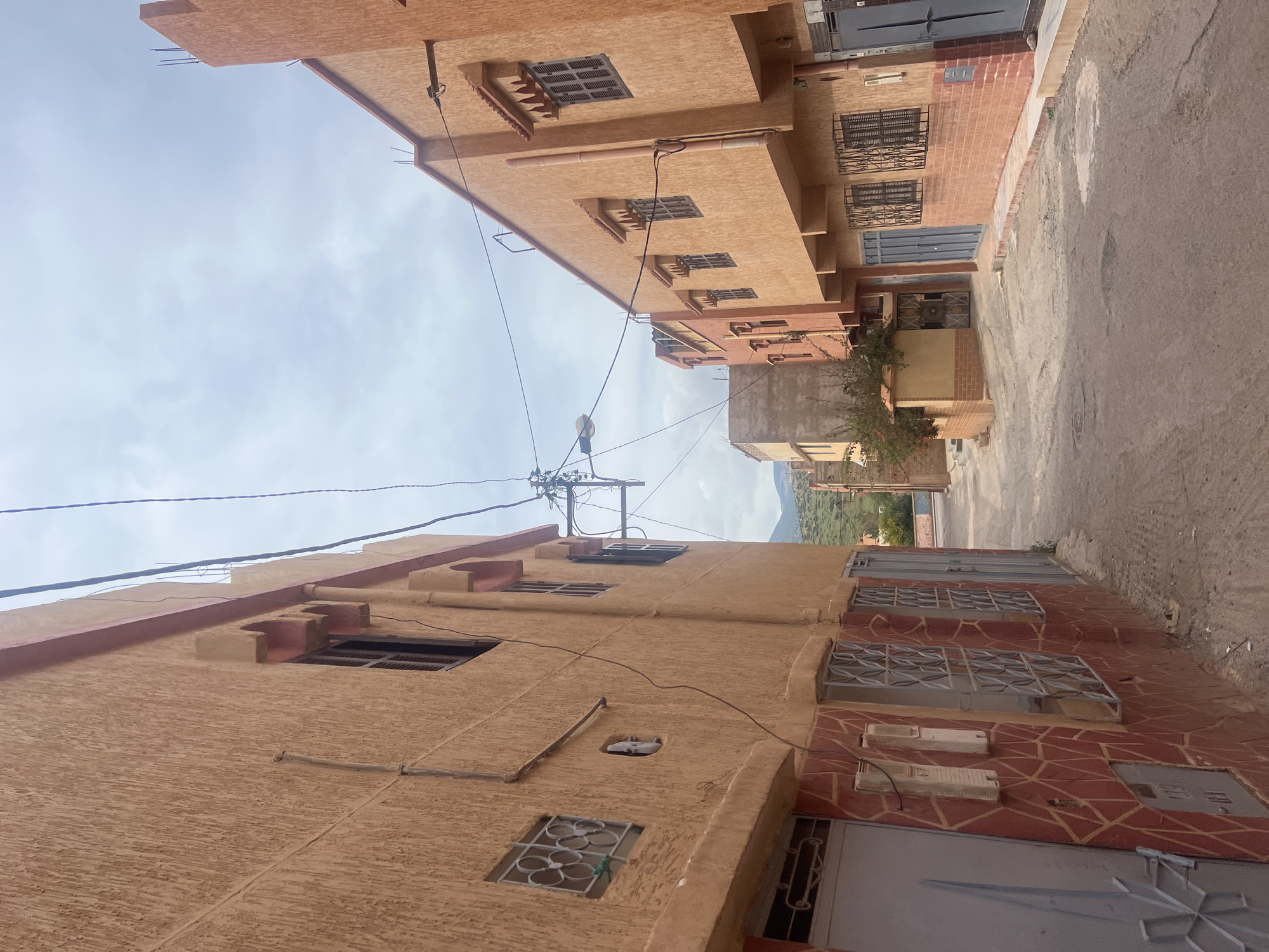 Driver documents street scenes during journey through Ouaouizert, Morocco