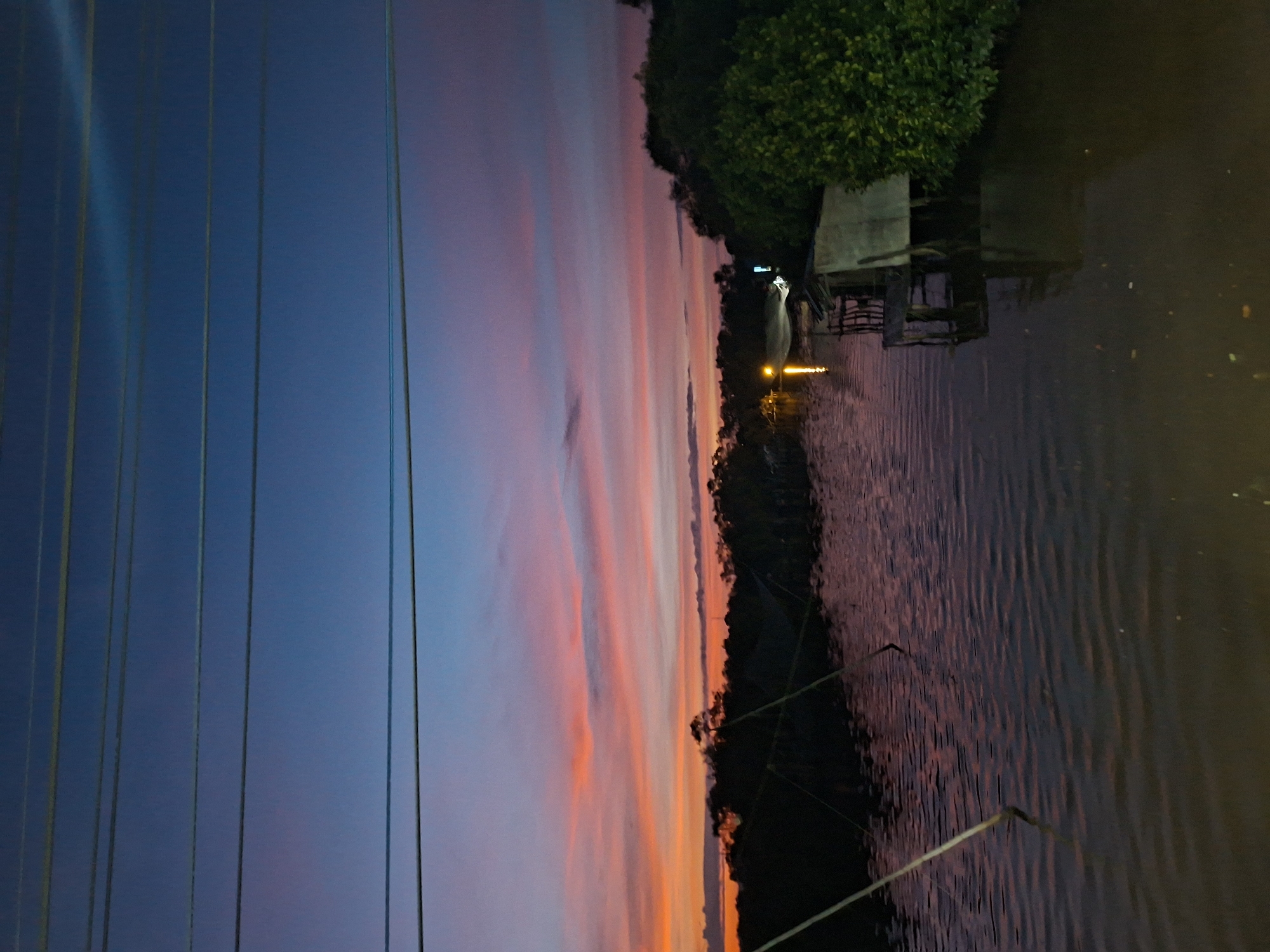 Dramatic sunset captured along Lhokseumawe waterway, Indonesia