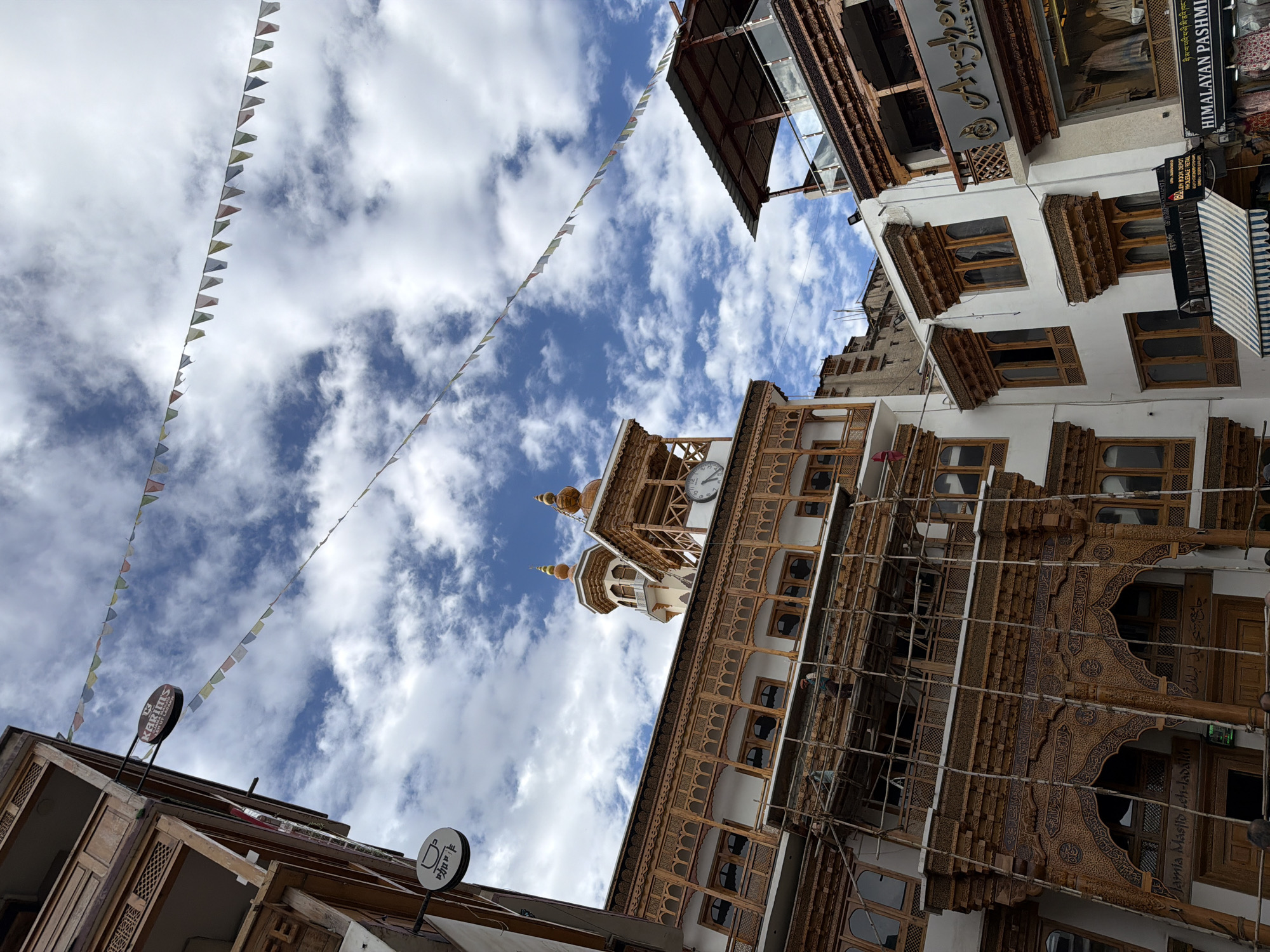 Leh's market street: prayer flags, Buddha statue, street fair