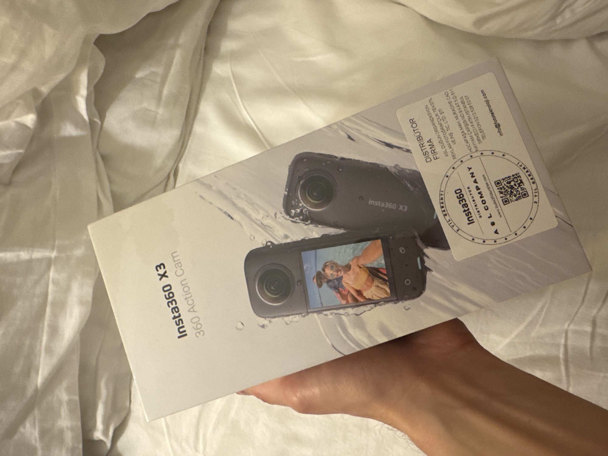 Person holds new action camera box in Bodrum bedroom