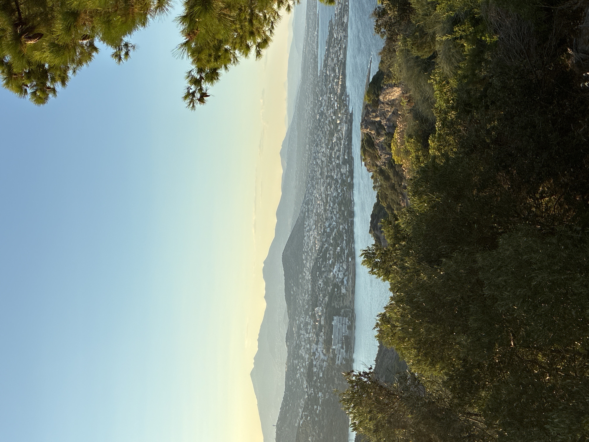 Golden hour over the hills and coast of Limenas Markopoulou