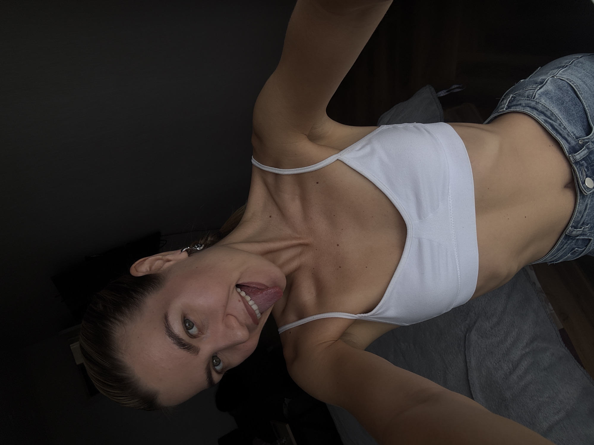 Woman sticks tongue out indoors, captured by witness