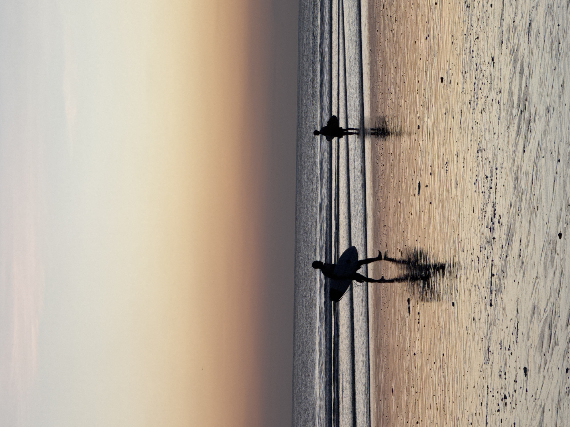 Sunset beach scene with surfers at Kuta Indonesia