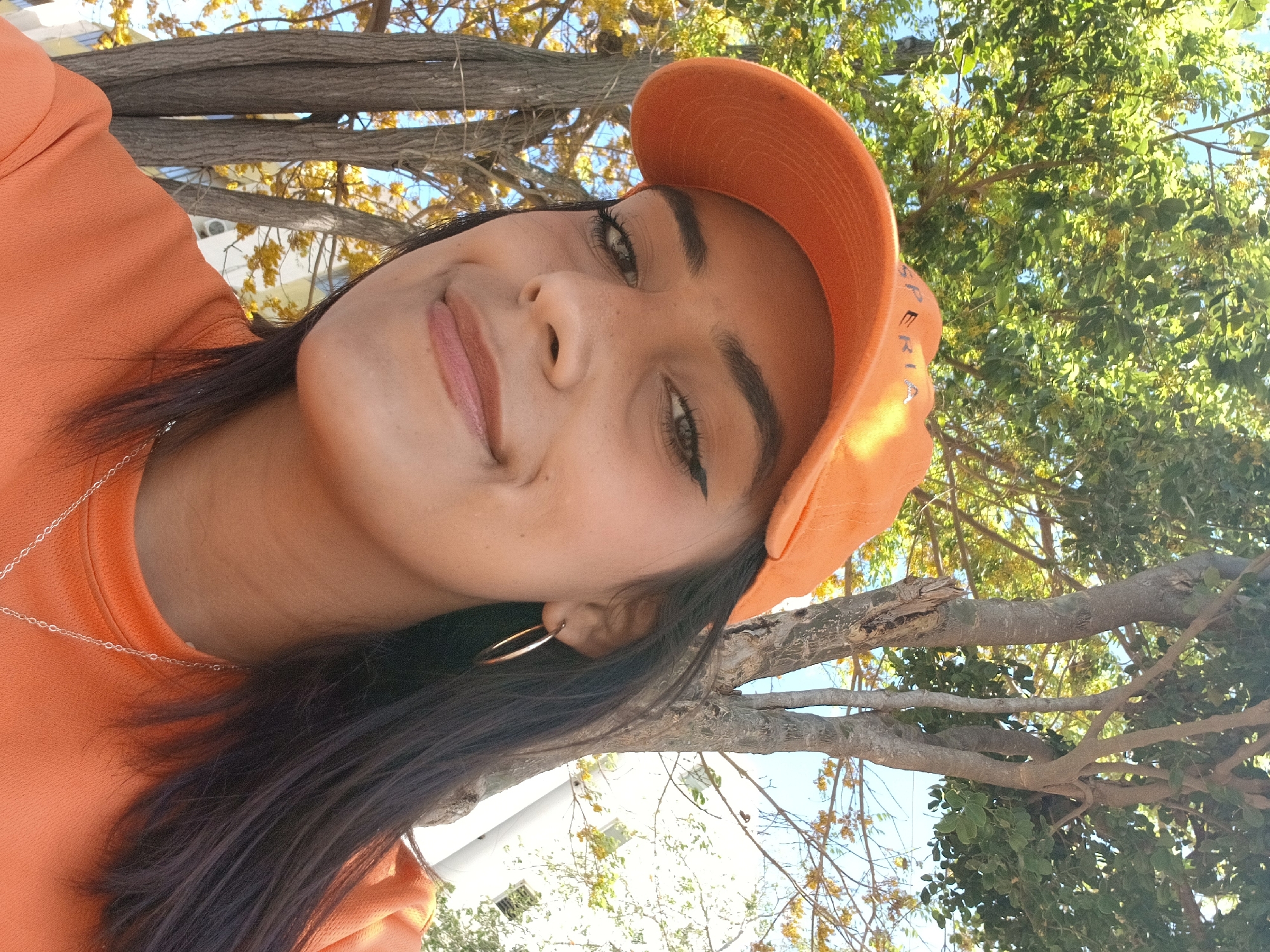 Woman takes selfies among blooming trees in Altagracia, Venezuela