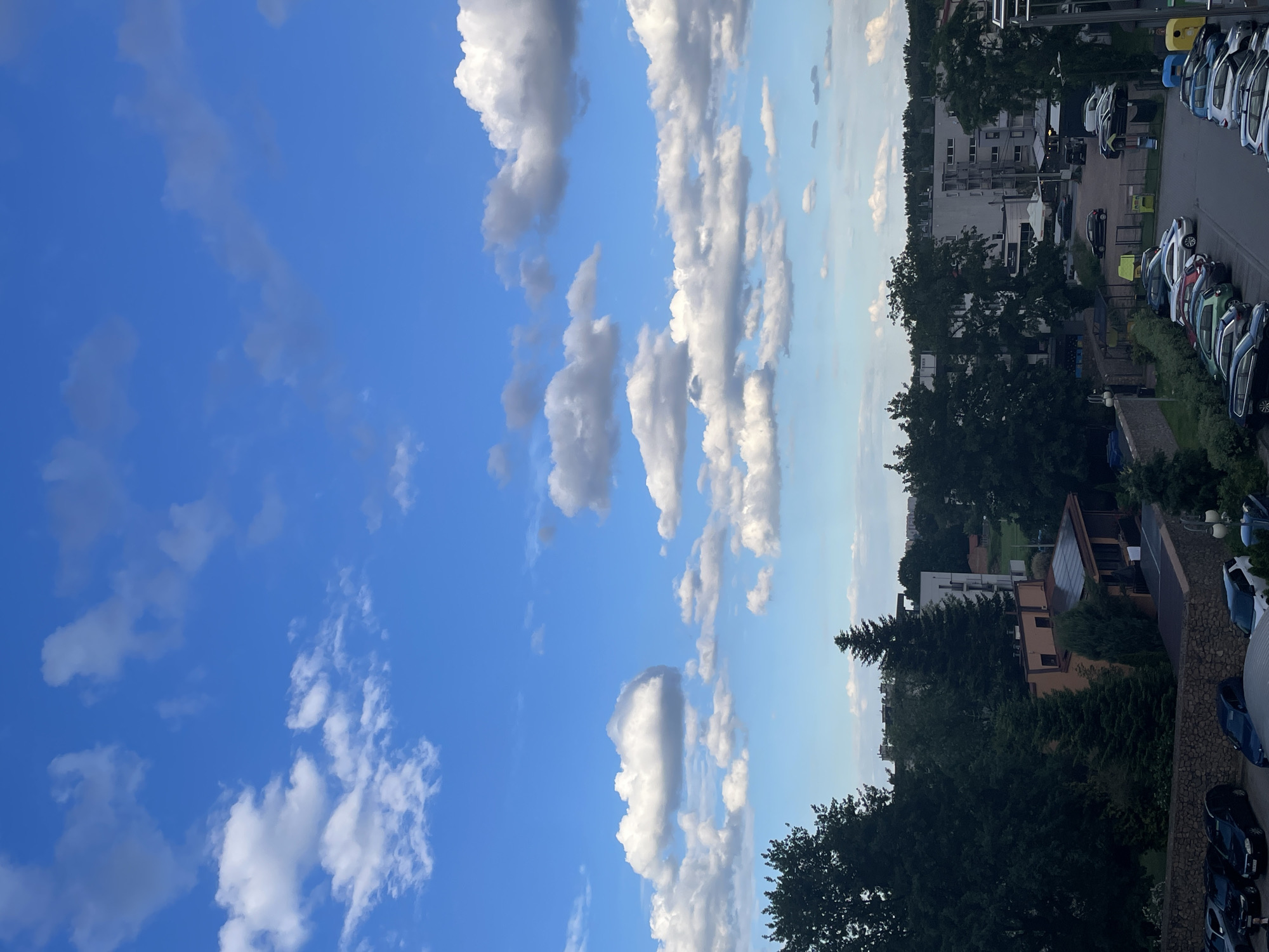 Dramatic clouds gather over residential district as observers document sky