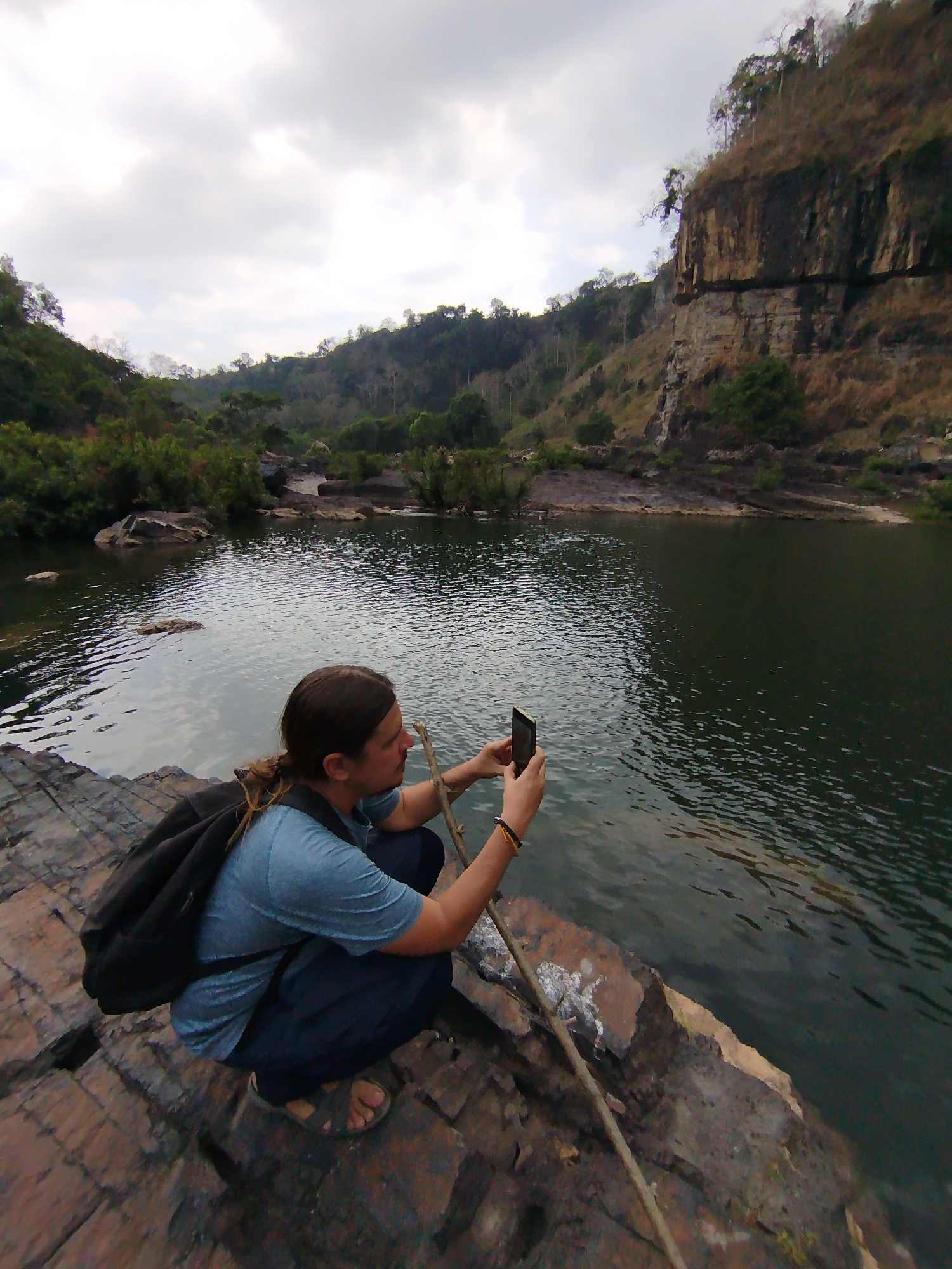 Morning hiker explores rocky riverbed terrain in Tân Phú Vietnam