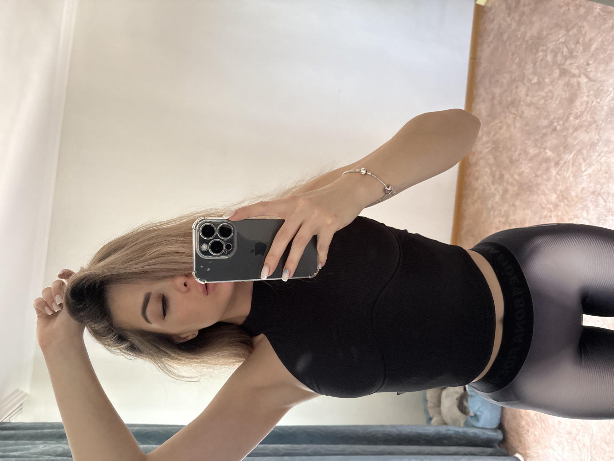Woman takes mirror selfies with iPhone in morning session