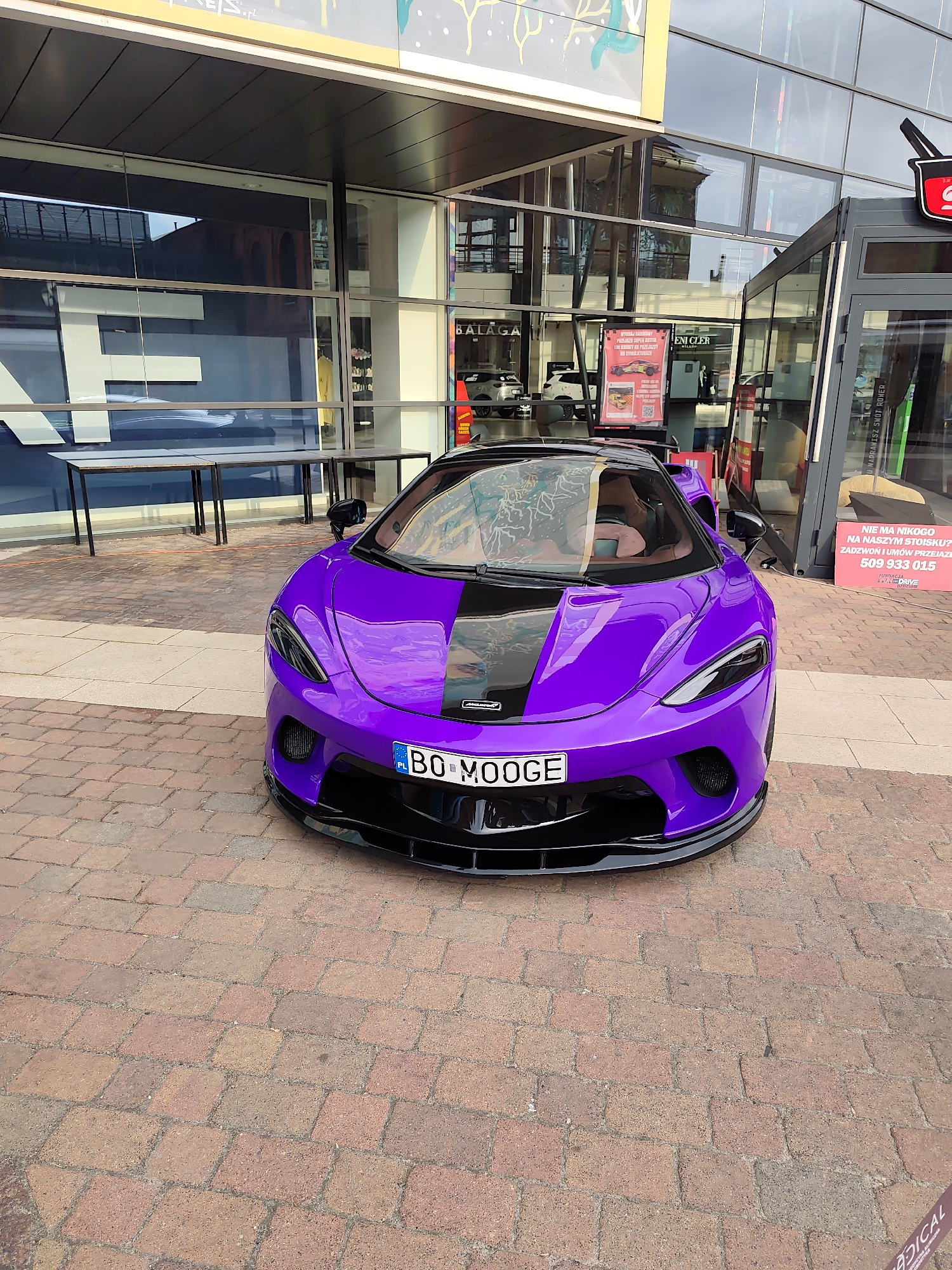 Purple McLaren parked outside Manufaktura complex in Łódź