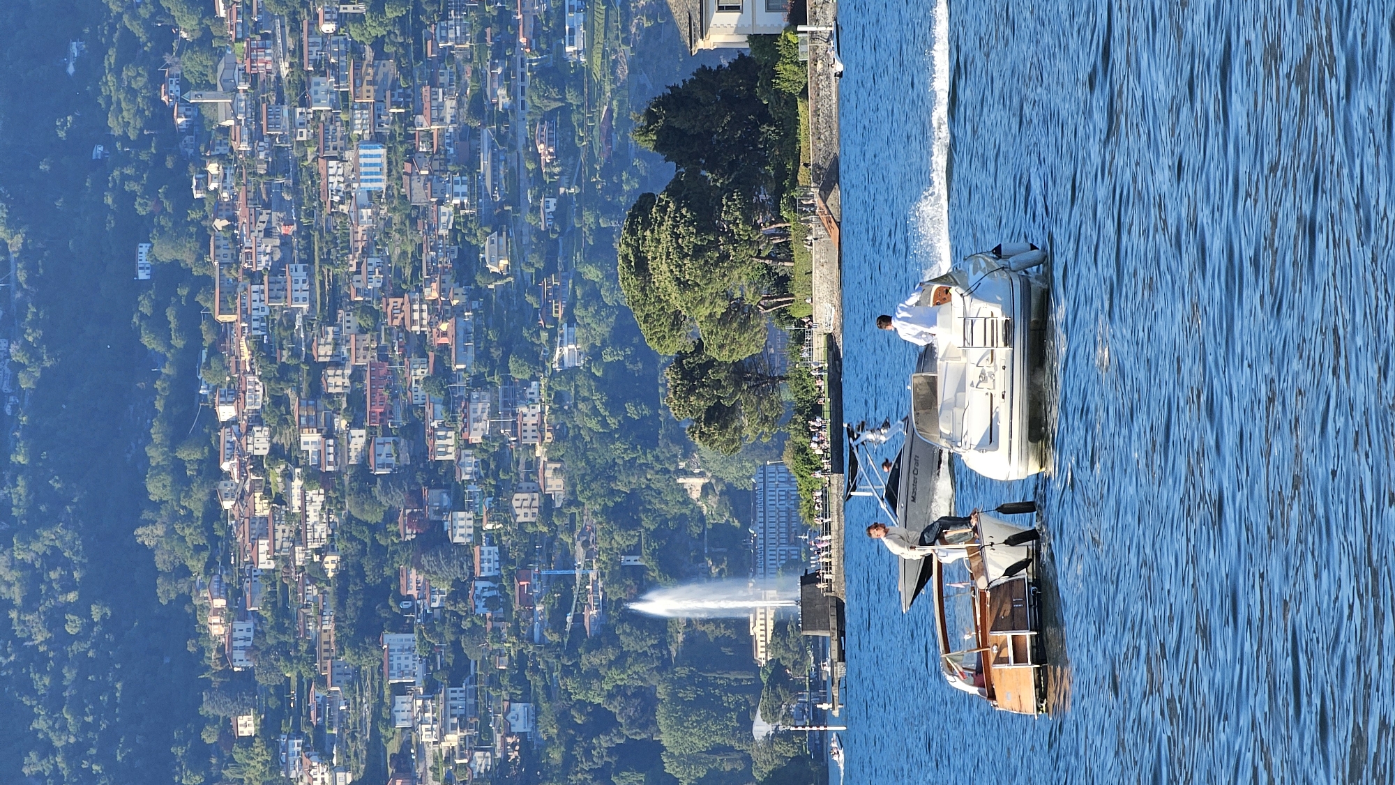 Boats spotted on sunny Lake Como afternoon