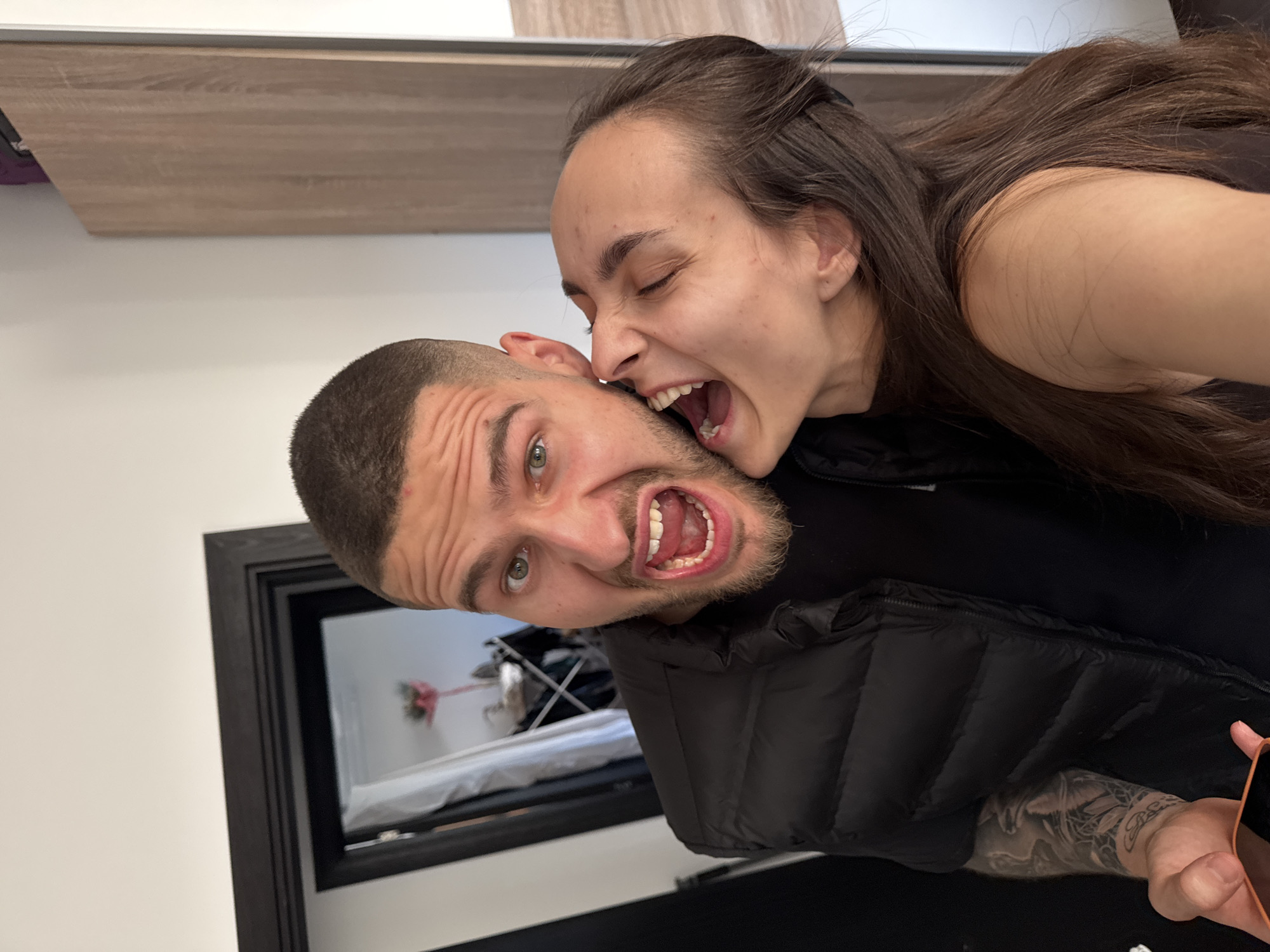 Couple Takes Multiple Mirror Selfies in Sofia Bedroom