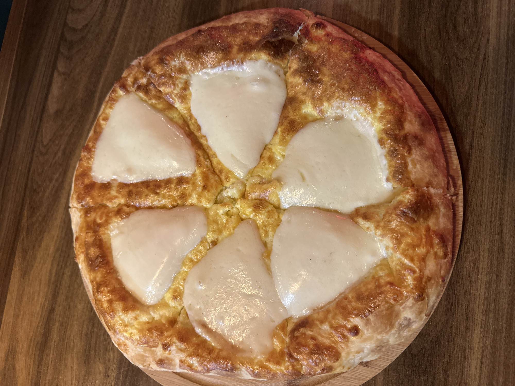 Round cheese-topped dish documented in Zestaponi, Georgia