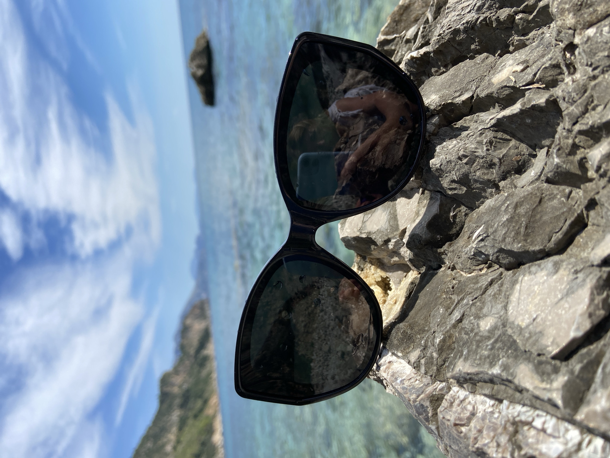 Woman relaxes on rocky Adriatic coast near Prijevor, Montenegro