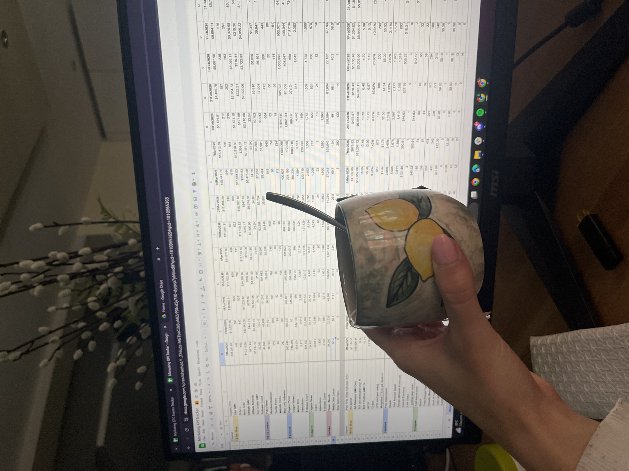 Office worker reviews marketing data with lemon mug